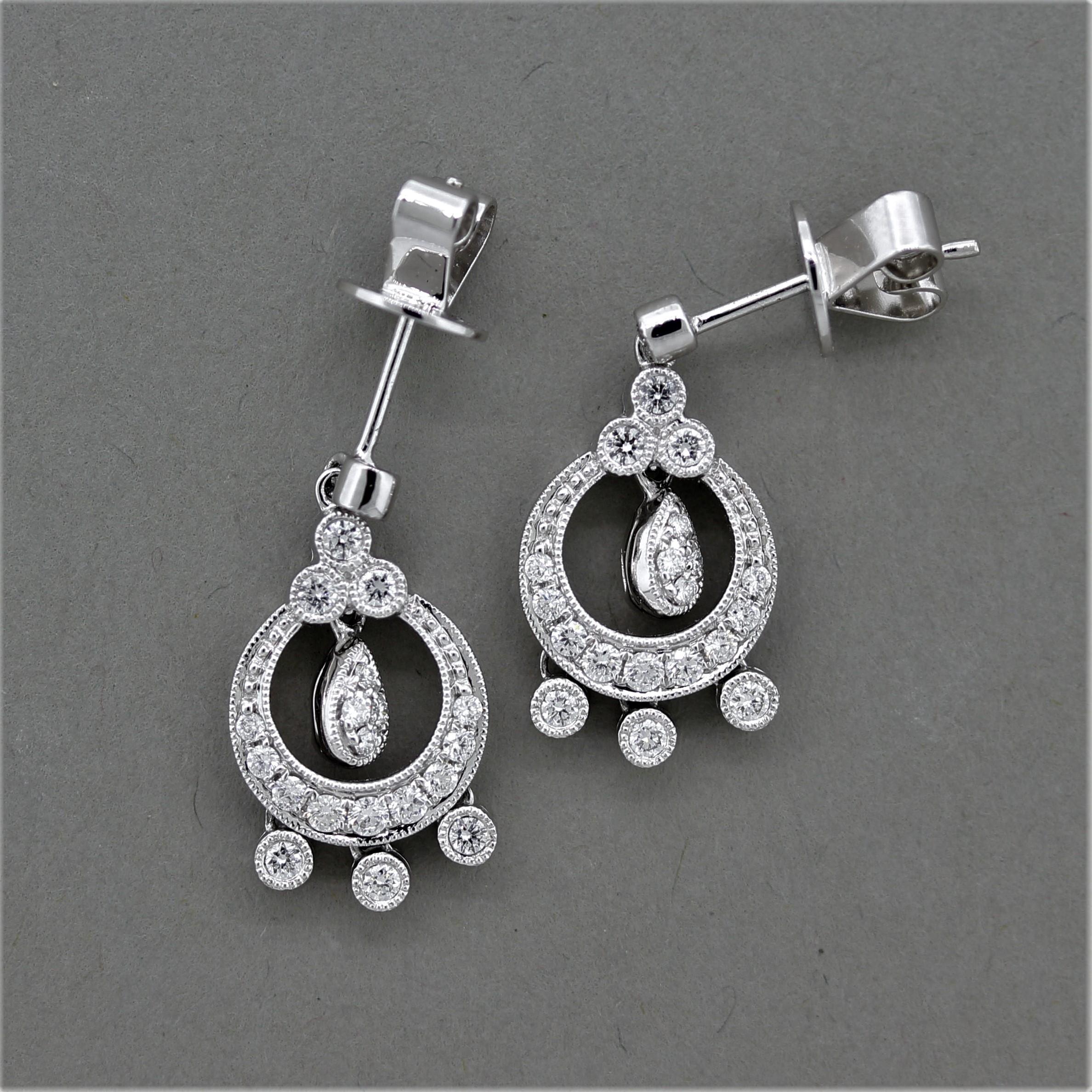 A stylish pair of earrings featuring 0.50 carats of round brilliant cut diamonds. They are set around the 18k white gold earrings and have a milgrain finish around the settings in an antique styled design.

Length: 0.9 inches