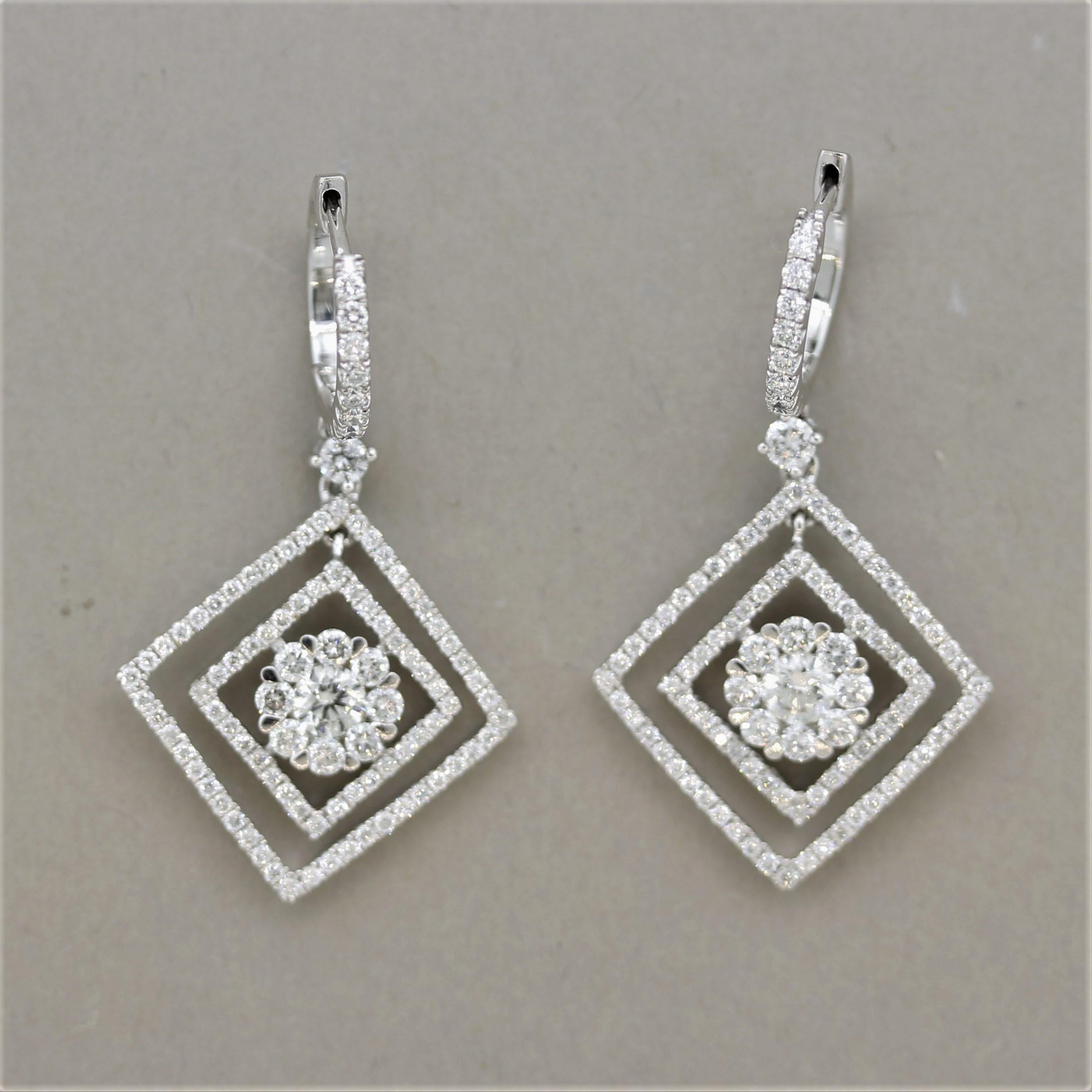 A chic and stylish pair of diamond earrings with great movement. They feature 2.00 carats of fine round brilliant-cut diamonds set around the earrings. The center of the earrings have a larger round diamond haloed by smaller round-cuts giving it a