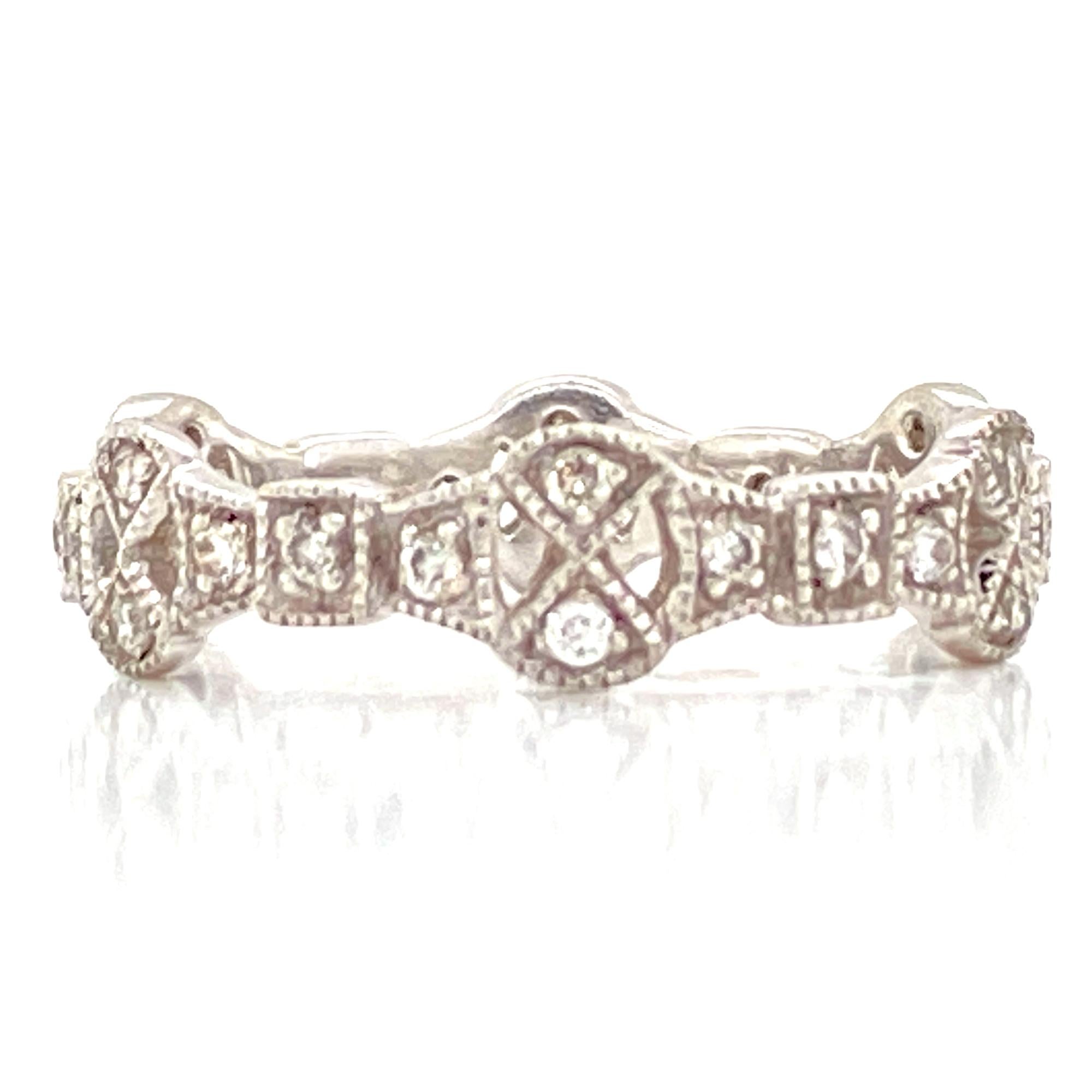 Diamond filigree Deco style eternity band crafted in platinum. The band features .30 carat total weight of round brilliant cut diamonds graded H-I color and SI clarity.  The band is size 7 and measures approximately 5mm in width. 