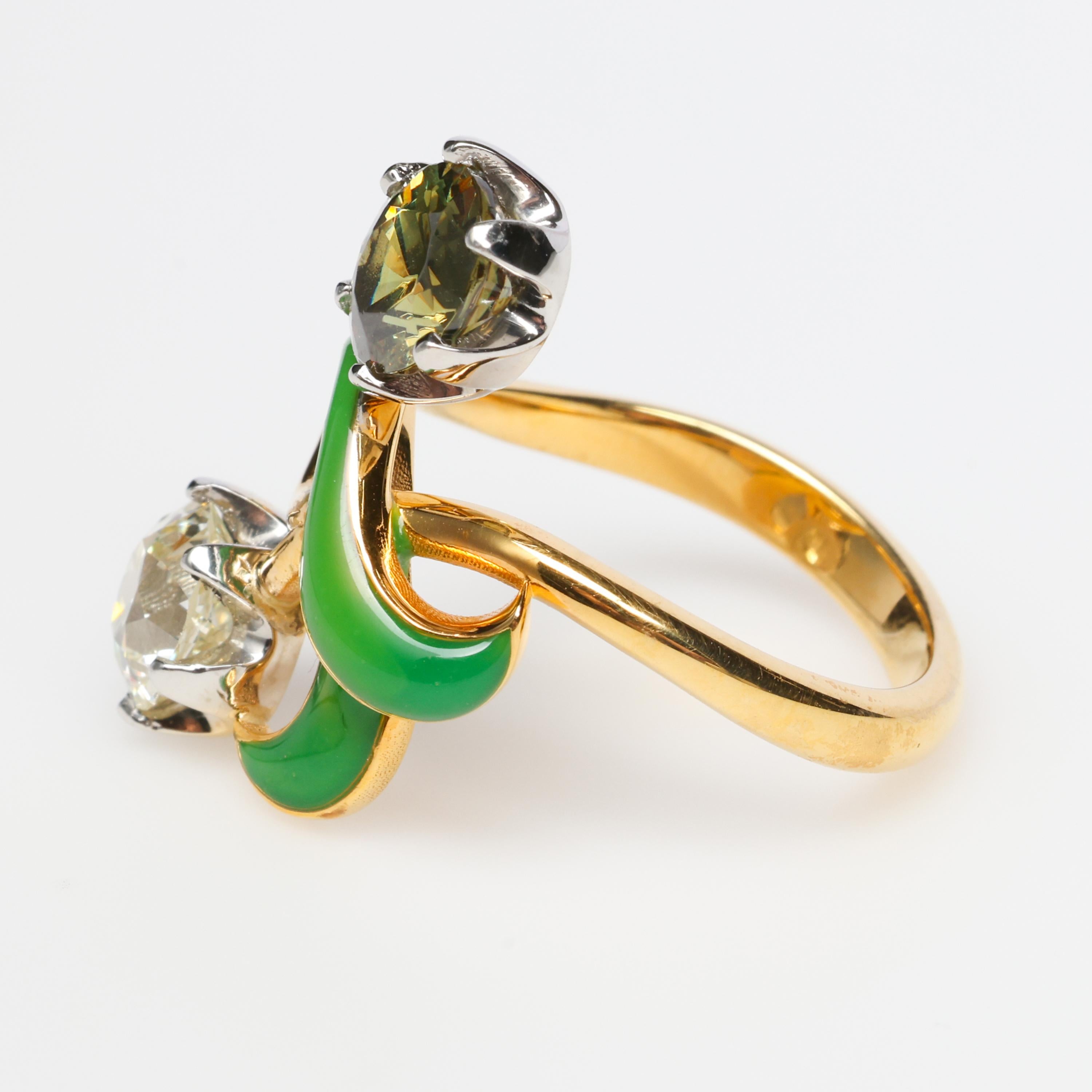 A 1.50-carat diamond and an over 2-carat demantoid garnet are the dazzling co-stars in this contemporary 14K yellow gold ring created in the style of the Russian Art Nouveau.  The very rare and very large demantoid garnet measures approximately