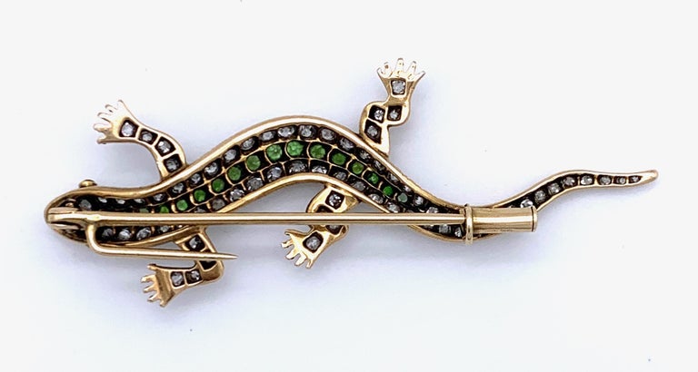 Brooch shaped as a lizard and set with diamonds and demantoids mounted in 14K gold.

