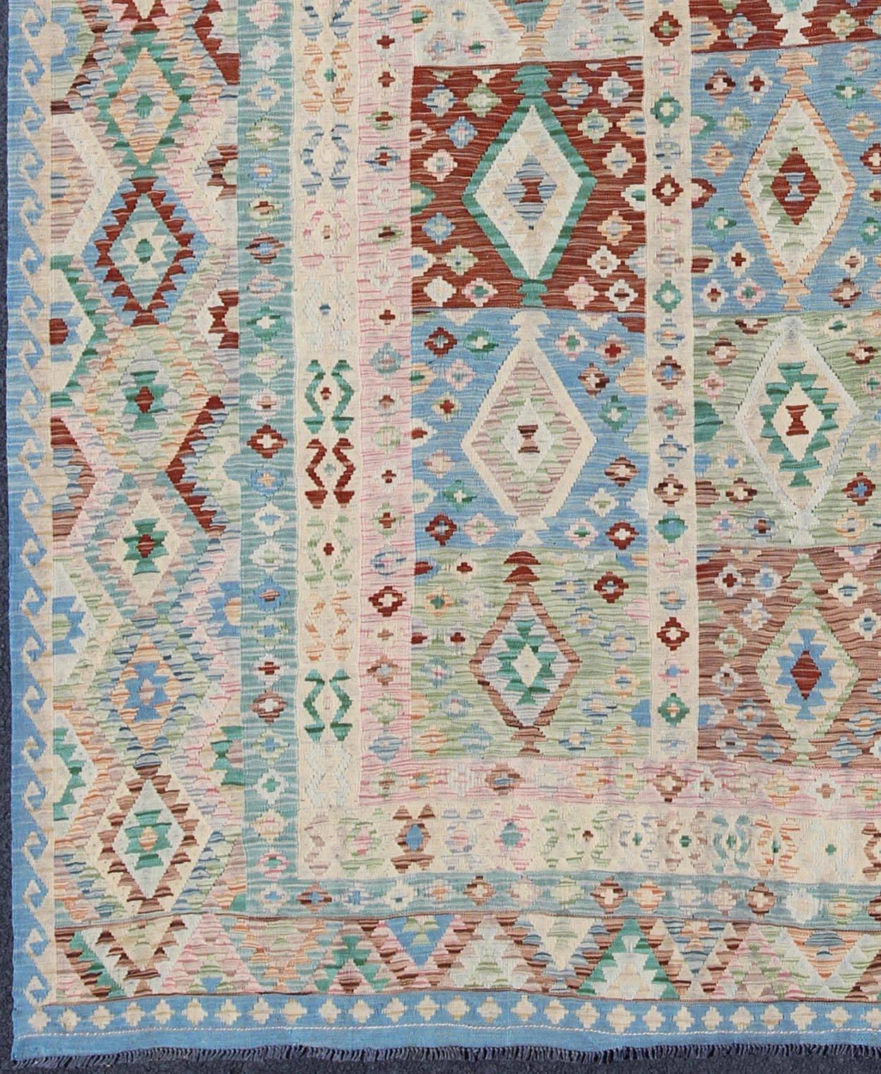 Diamond design geometric Afghan made Kilim rug in blue, green, cream, pink, rug Keivan Woven Arts / orn-30108, country of origin / type: Afghanistan / Kilim.

This flat-weave Kilim from Afghanistan bears a repeating diamond design with other