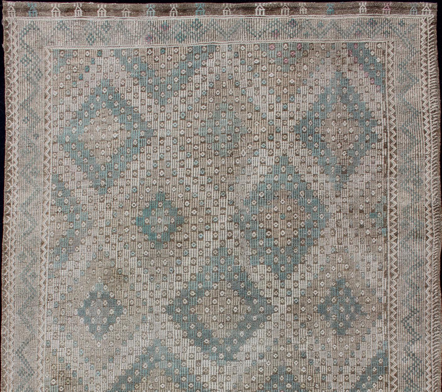 Turkish vintage Embroidered flat woven carpet, rug EN-179404, country of origin / type: Turkey / Oushak, circa 1940

This Embroidered kilim rug from Turkey features an all-over layered diamond and geometric design rendered in natural tones and