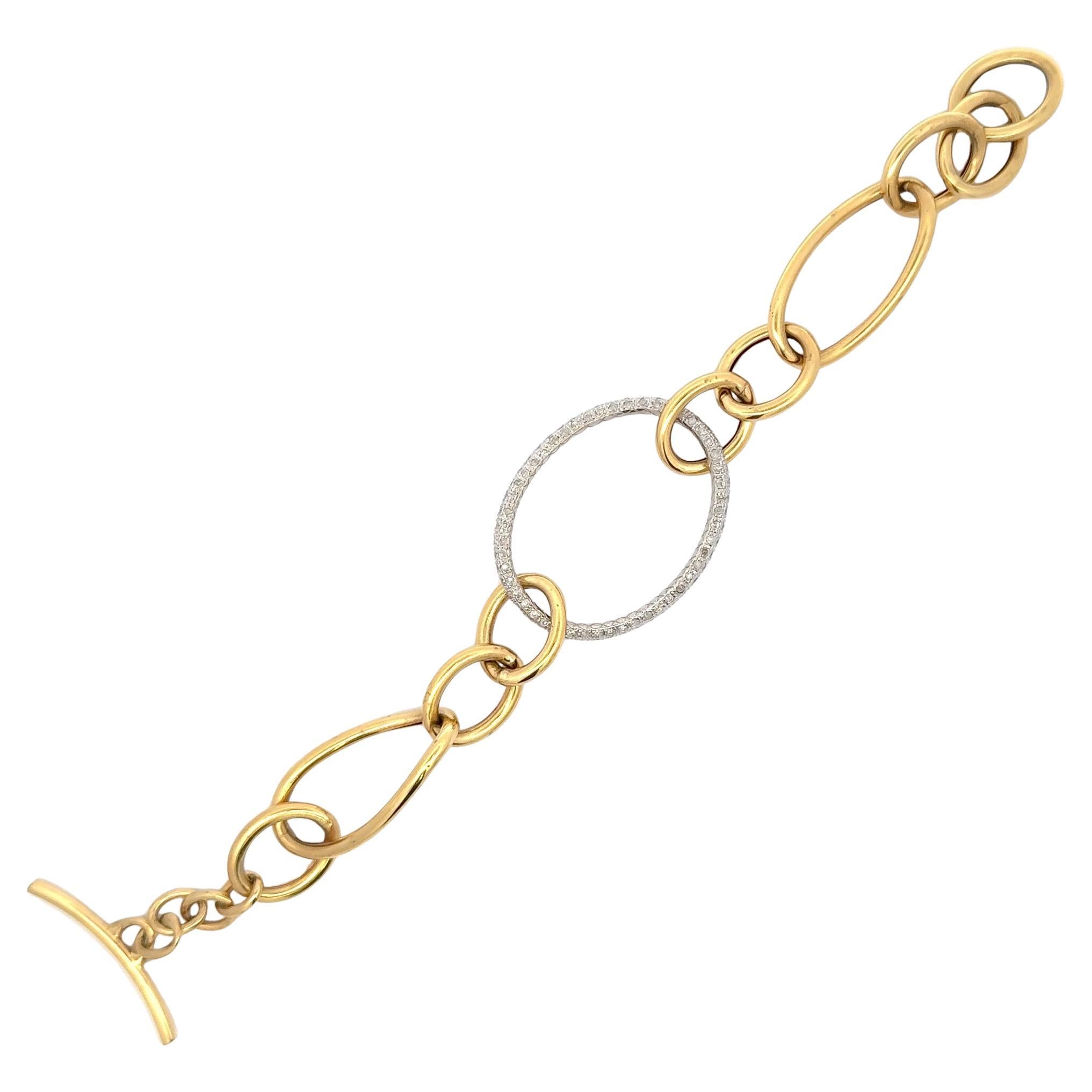 18 Karat yellow gold bracelet featuring a diamond center oval link and alternation medium to small size links, 17.2 grams.