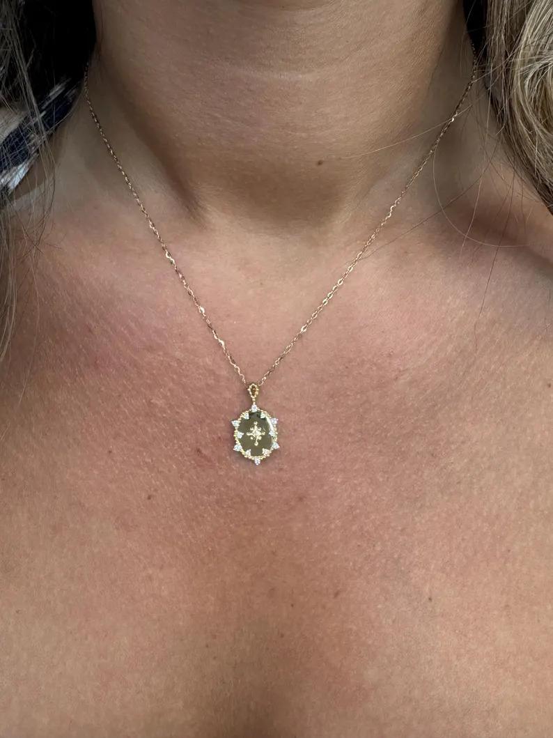 18 Karat yellow gold pendant featuring an oval shape disc with a beaded trim and scattered diamonds, 13 round brilliants weighing 0.15 carats, 3.27 grams.

More Fashion Pendants in Stock
Search Harbor Diamonds
Message for pictures & details. 
