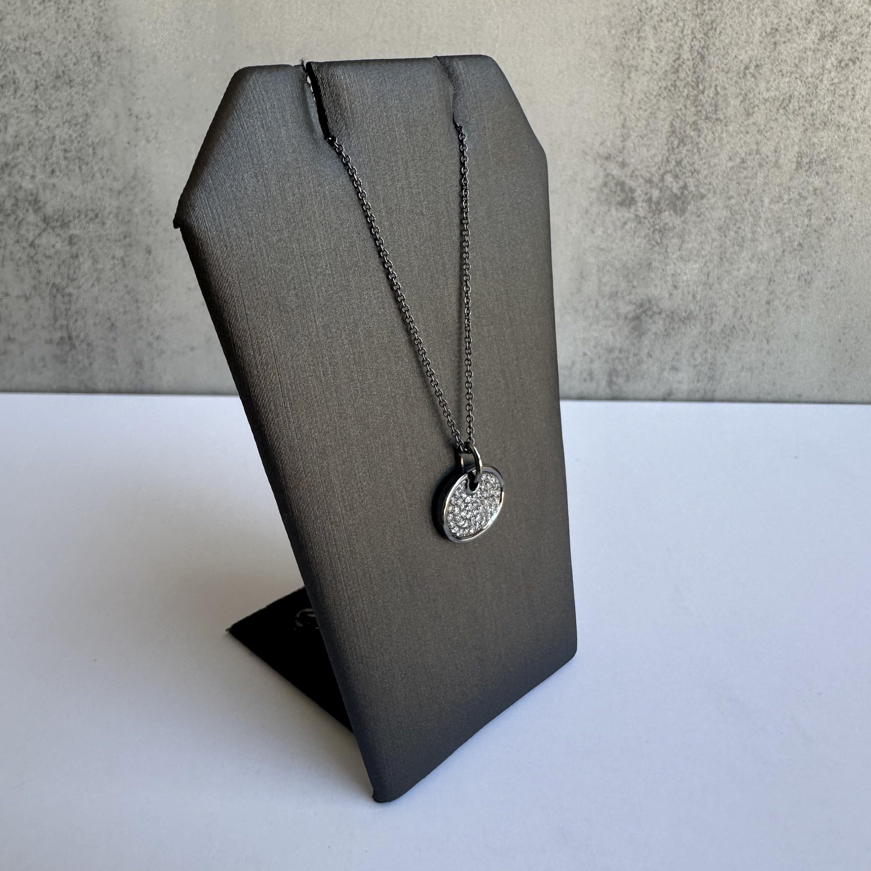 Enhance your jewelry collection with this exquisite Diamond Disc Necklace in 14kt Gold with Black Rhodium Plating. Featuring 0.18 carats of GH VS/SI natural round single cut diamonds, this necklace combines timeless beauty with modern elegance,