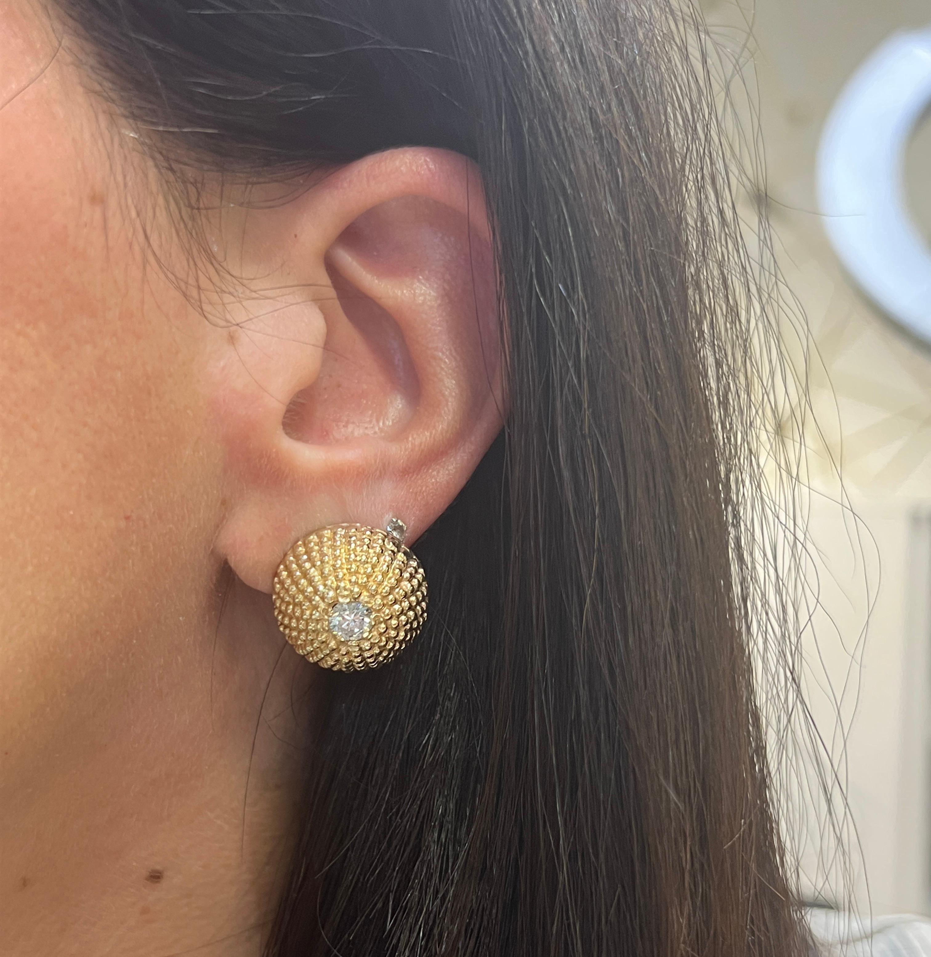 Diamond Dome Earrings 

Textured yellow gold earrings set with two round cut diamonds. 

Total Approximate Diamond Weight: 1.86 carats
Approximate Diameter: .75 inches
Approximate Weight: 15.9 grams
Back Type: clip-on with post
Metal Type:  14 karat