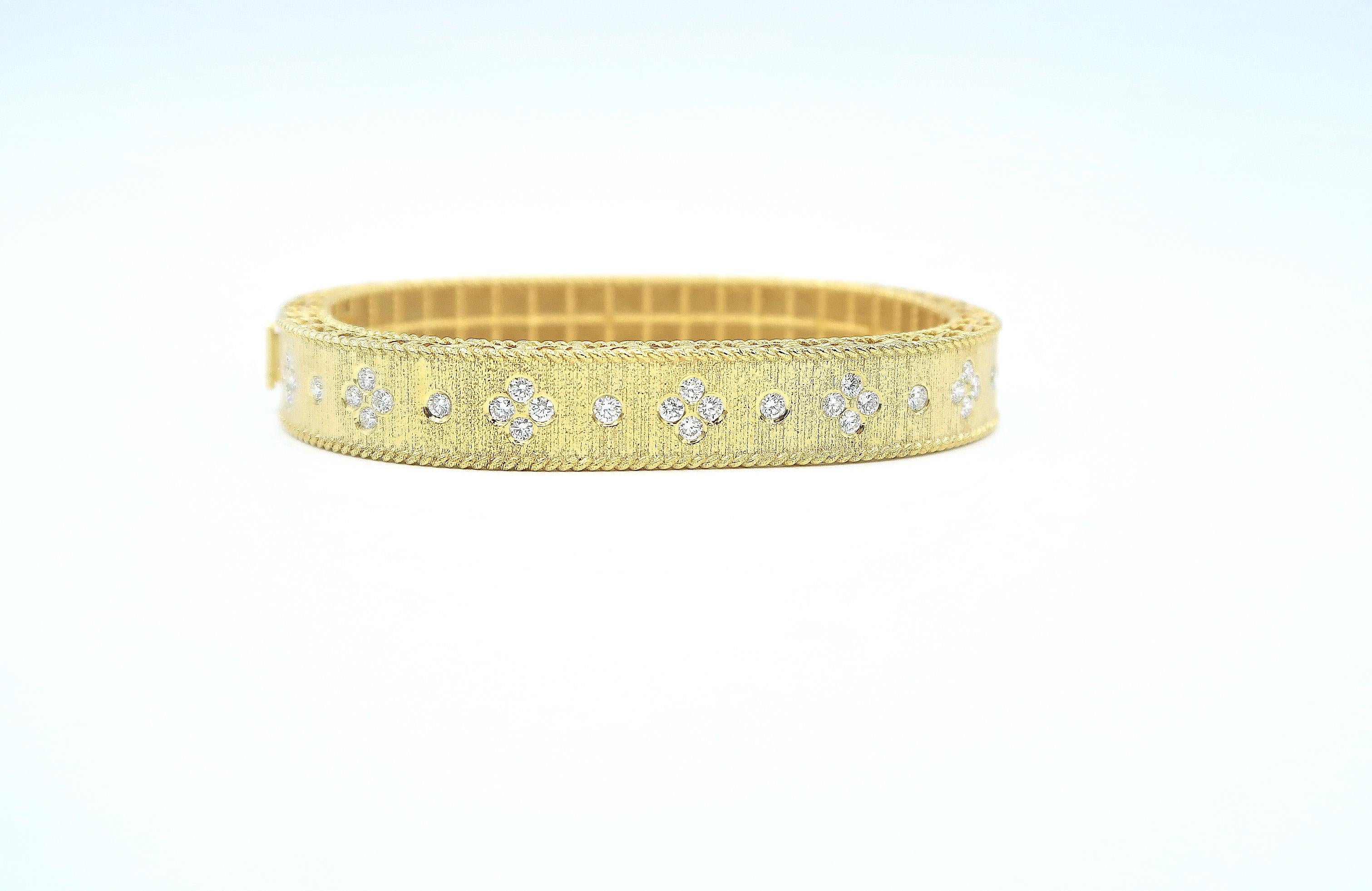 Diamond Dotted Sateen Finish Engraved Surface 18 Karat Yellow Gold Bangle in Rounded Rectangular Shape

Gold: 18K Yellow Gold, 30.96 g
Diamond: Brilliant, 1.18 ct