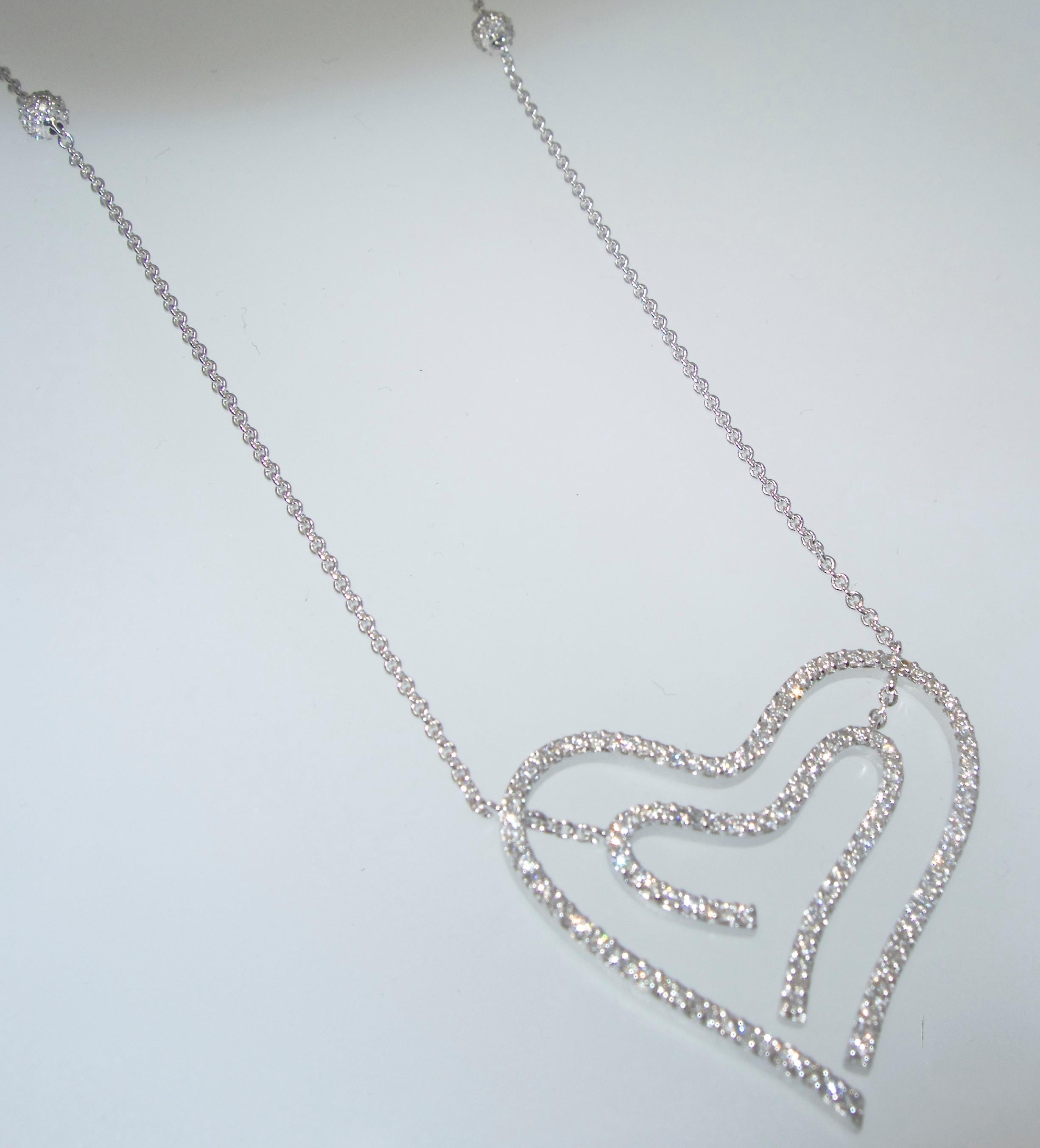 The heart pendant is set with fine white diamonds.  These diamonds are all well matched and well cut, they weigh approximately 1 ct.  These modern brilliant cut diamonds are approximately H color - near colorless - and very slightly included, VS. 