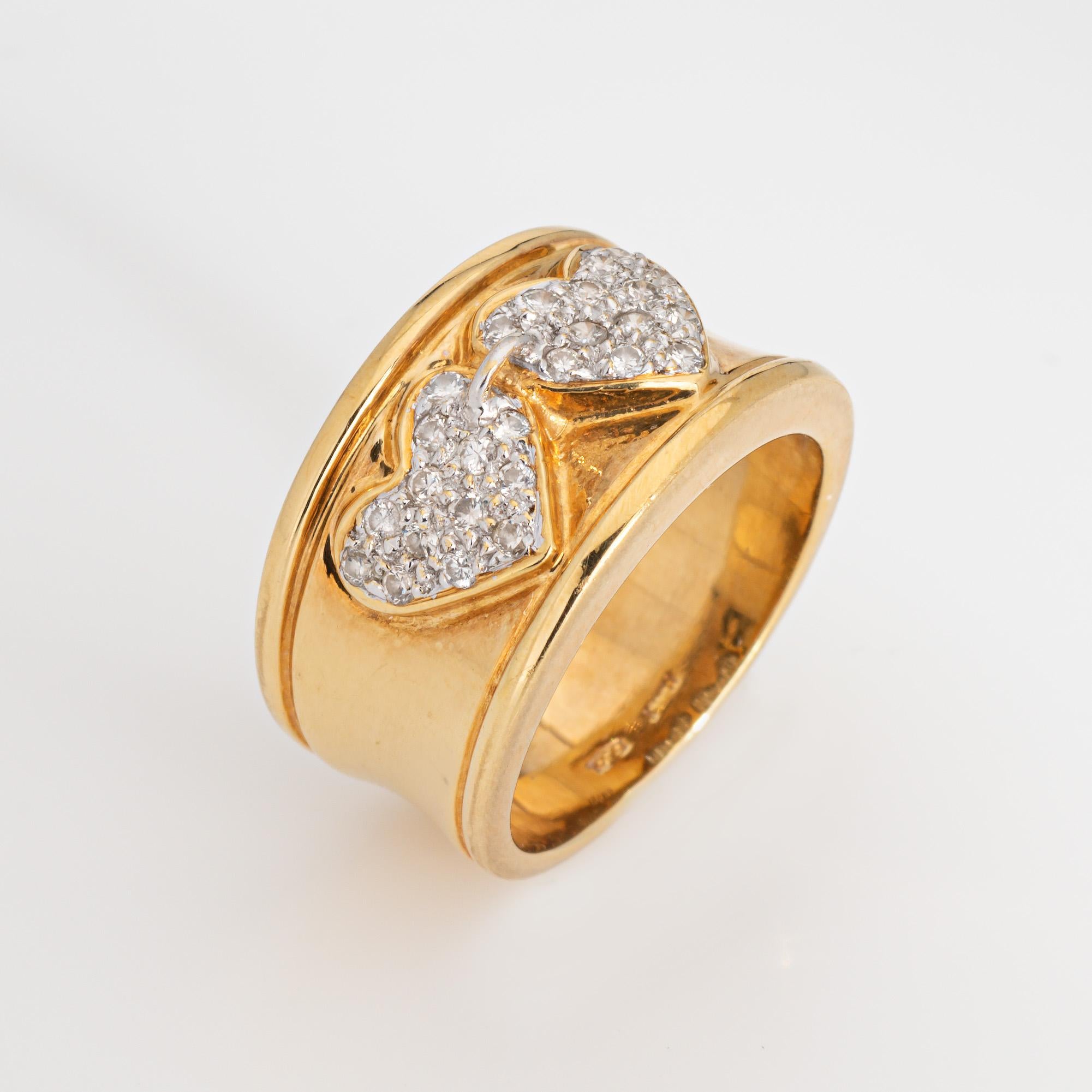 Finely detailed vintage diamond double heart ring crafted in 18k yellow gold (circa 1980s to 1990s). 

Diamonds total 0.29 carats (estimated at H-I color and VS1-SI2 clarity).   

Diamonds are pave set into the two hearts, linked together with a