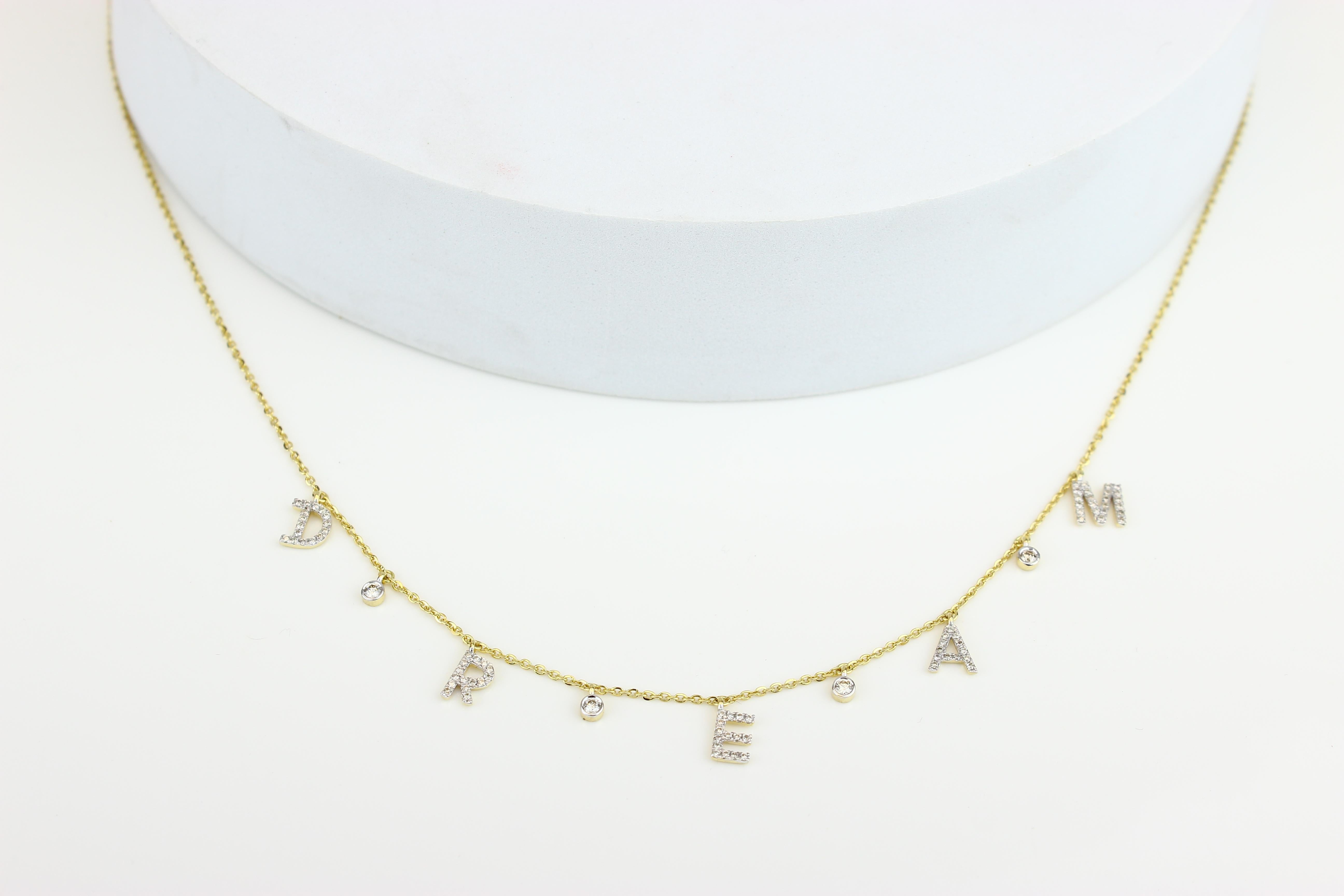 The Diamond Love Necklace is a stylish symbol of hope and inspiration, made of gold and diamonds. Each letter is uniquely styled with a modern font and studded with diamonds. The pendant is arranged on a gold chain with diamond-studded charms for a