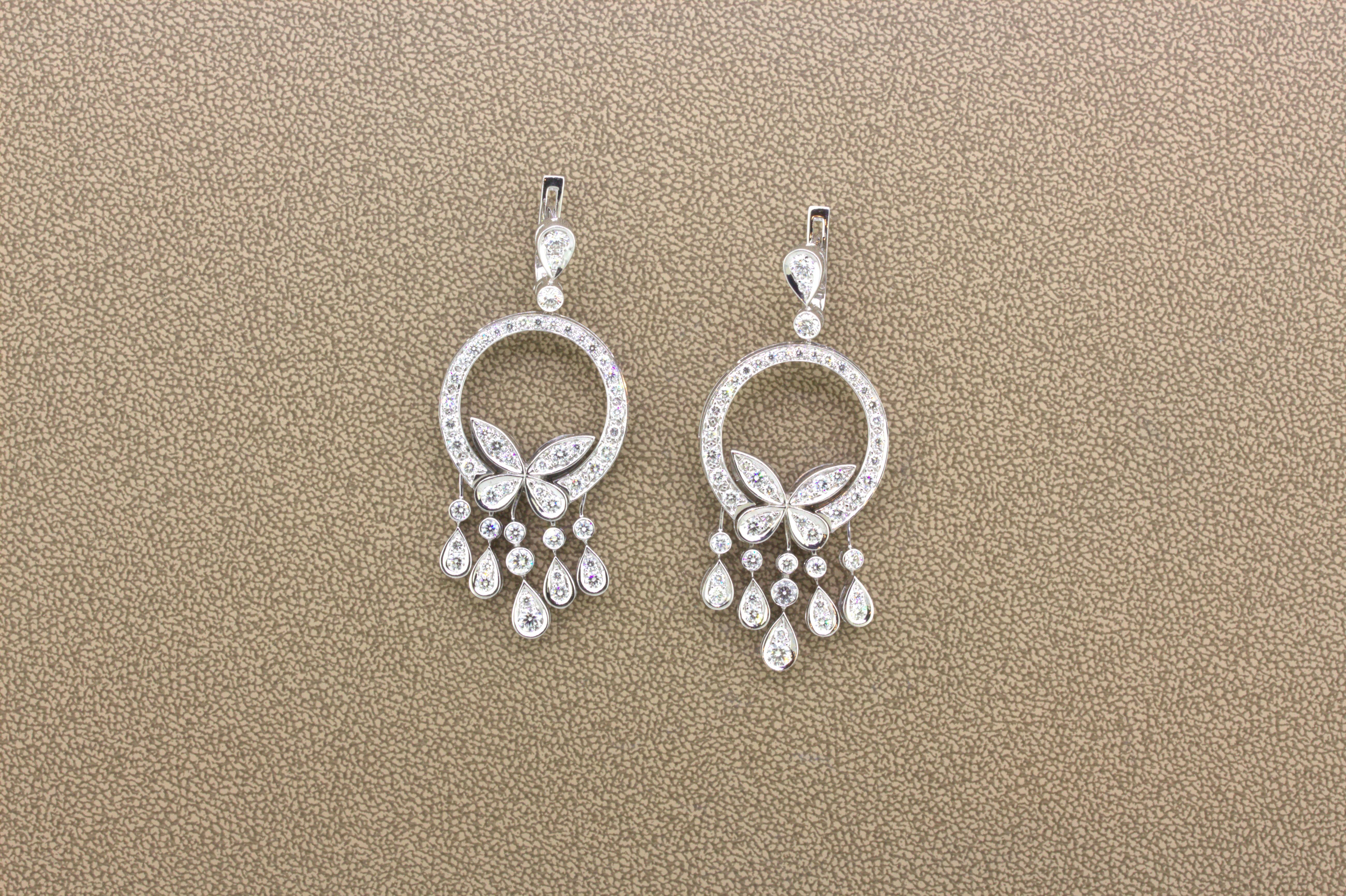 A chic and cute pair of diamond white gold earrings. They feature 4.12 carats of round brilliant-cut diamonds set around the earrings in pear-drops and in the shape of butterflies. They are made in 18k white gold with a very strong and sturdy