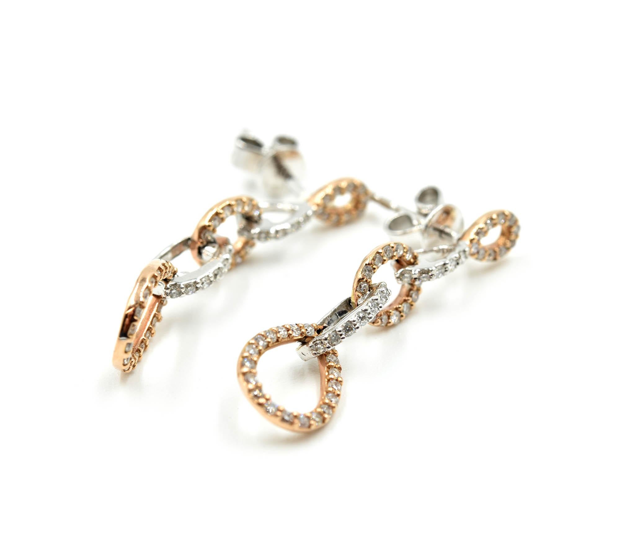 Designer: custom design
Material: 14k white and rose gold
Diamonds: 106 diamonds = 0.50 carat total weight
Dimensions: each earring is 1 1/4th inches long and 1/4th an inch long  
Fastenings: friction backs
Weight: 2.60 grams
