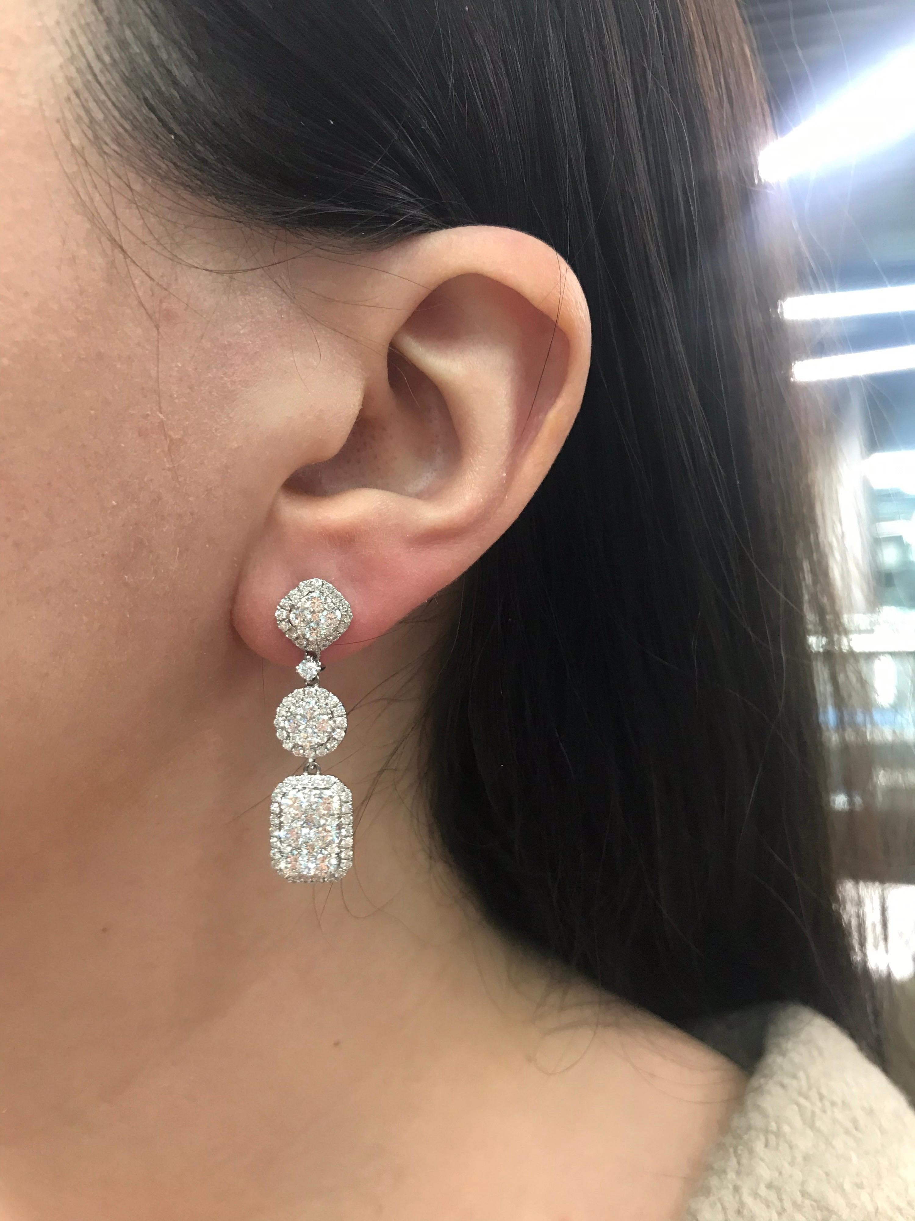 18K White gold drop earrings featuring 170 round brilliants weighing 2.41 carats and 12 round brilliants weighing 1.94 carats. 
Color G
Clarity SI

Great looking on!
