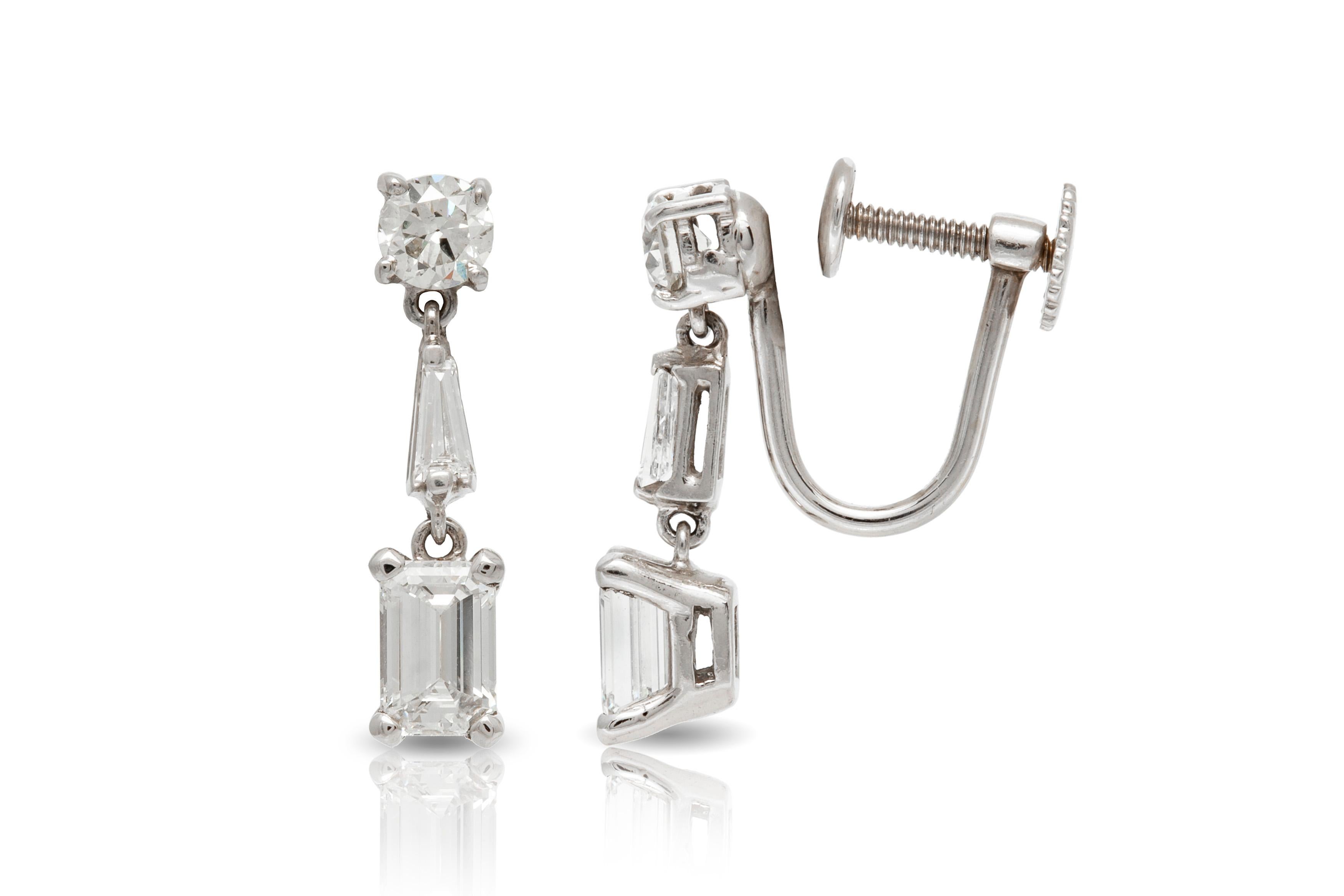 Earrings, finely crafted in platinum with emerald cut diamonds weighing approximately a total of 1.50 carat, round cut diamonds weighing approximately a total of 0.60 carat and baguette cut diamonds weighing approximately a total of 0.20 carat.