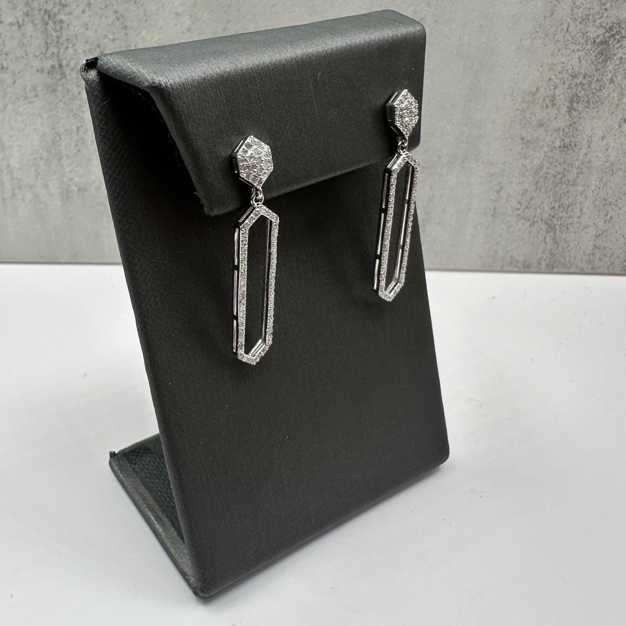 These elegant Diamond Drop Earrings in sterling silver feature approximately 0.50ctw of natural I, I quality round single-cut diamonds, offering brilliant sparkle in a timeless design. Weighing 3.4 grams, they provide a substantial yet comfortable