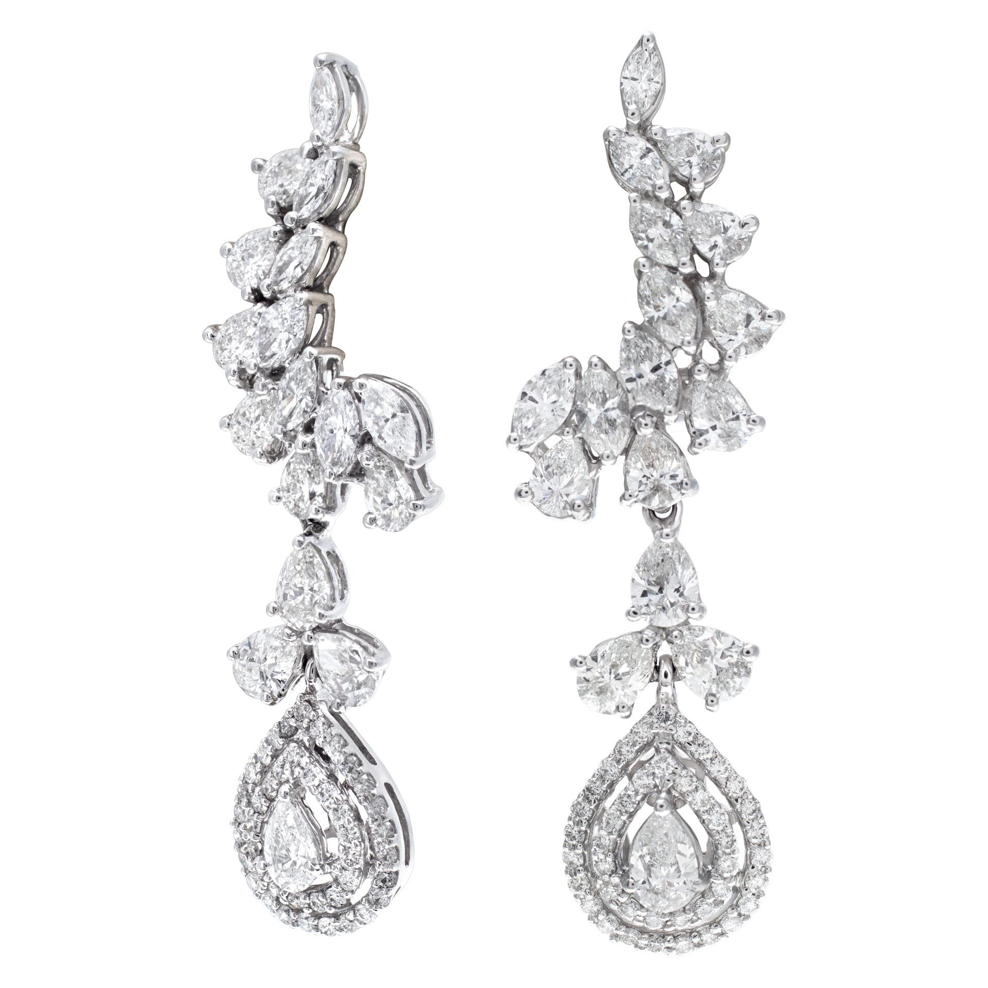 Dangling diamond earrings set in 18k white gold with approximately 5 carats of I-J color, SI clarity marquise, pear, and round cut diamonds. The dangling drop is a beautiful double halo of micro pave diamonds and center pear cut diamond is