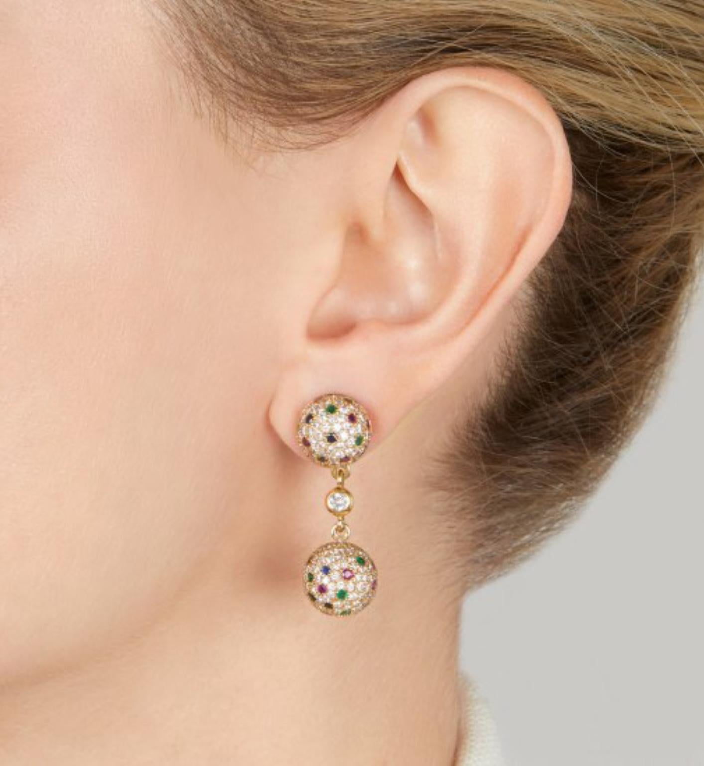 A chic pair of round brilliant-cut diamond and 18 karat yellow gold earrings with removable drops, embellished with round rubies, emeralds and sapphires. Length approximately 1.25 inches