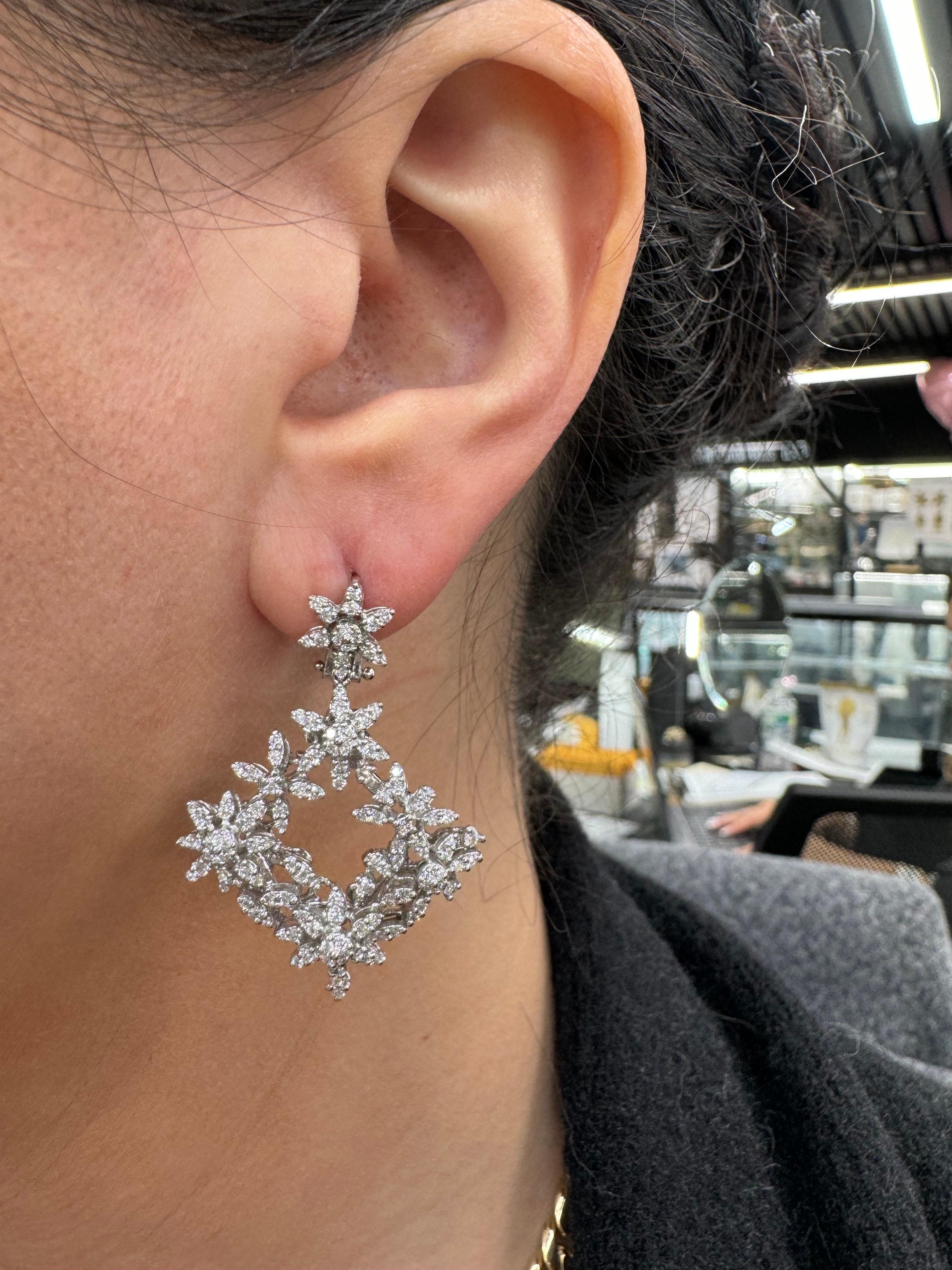 Diamond floral drop earrings featuring a cluster of 246 round brilliants weighing 1.85 carats, in 14 karat white gold.
Color F-G
Clarity VS1-VS2