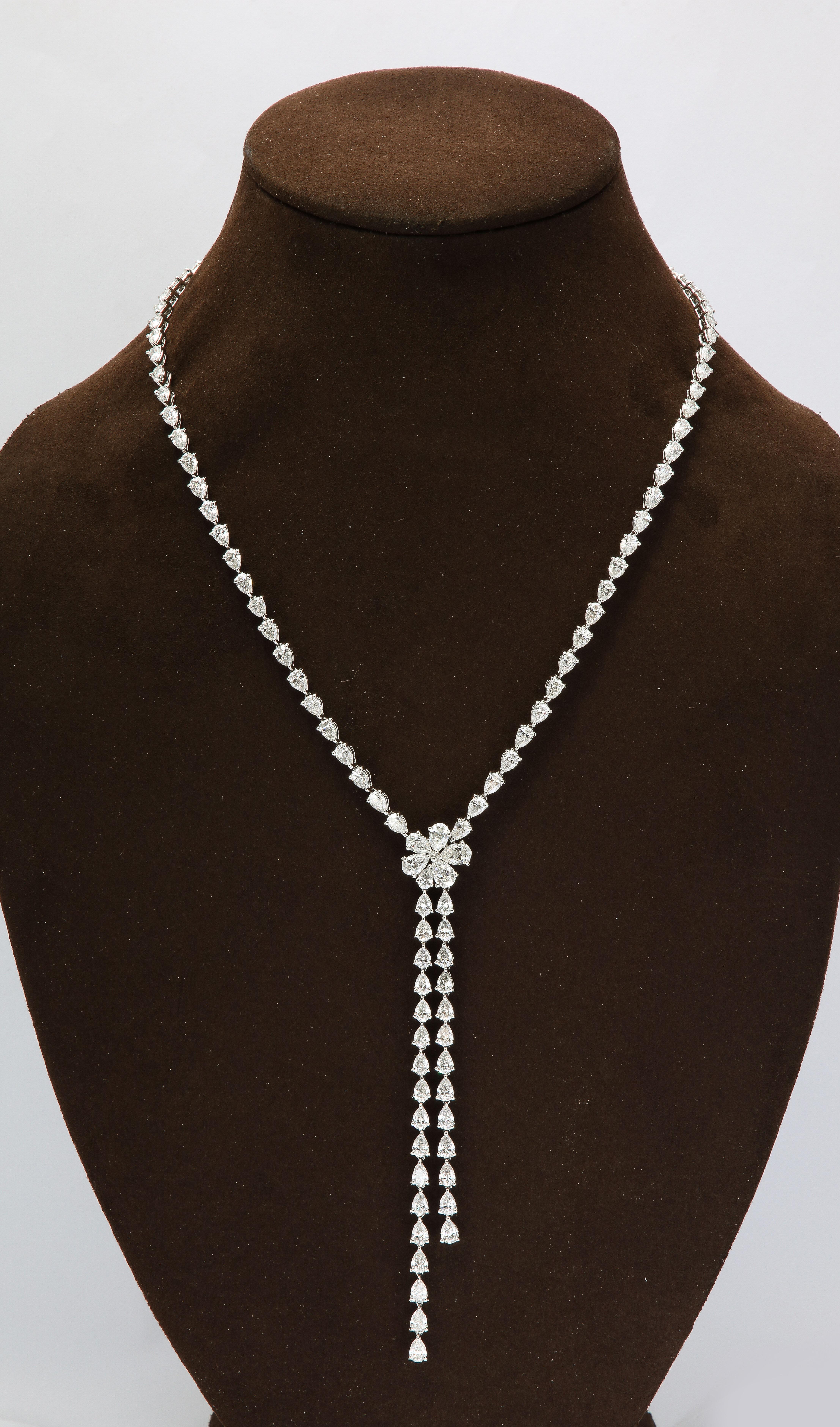 
A stunning, lariat style, drop necklace with a flower center. 

23.23 carats of white pear shape diamonds set in 18k white gold. 

17 inch length. 4 inch drop from center flower. 

Matching earrings are available in our 1stDibs store. 