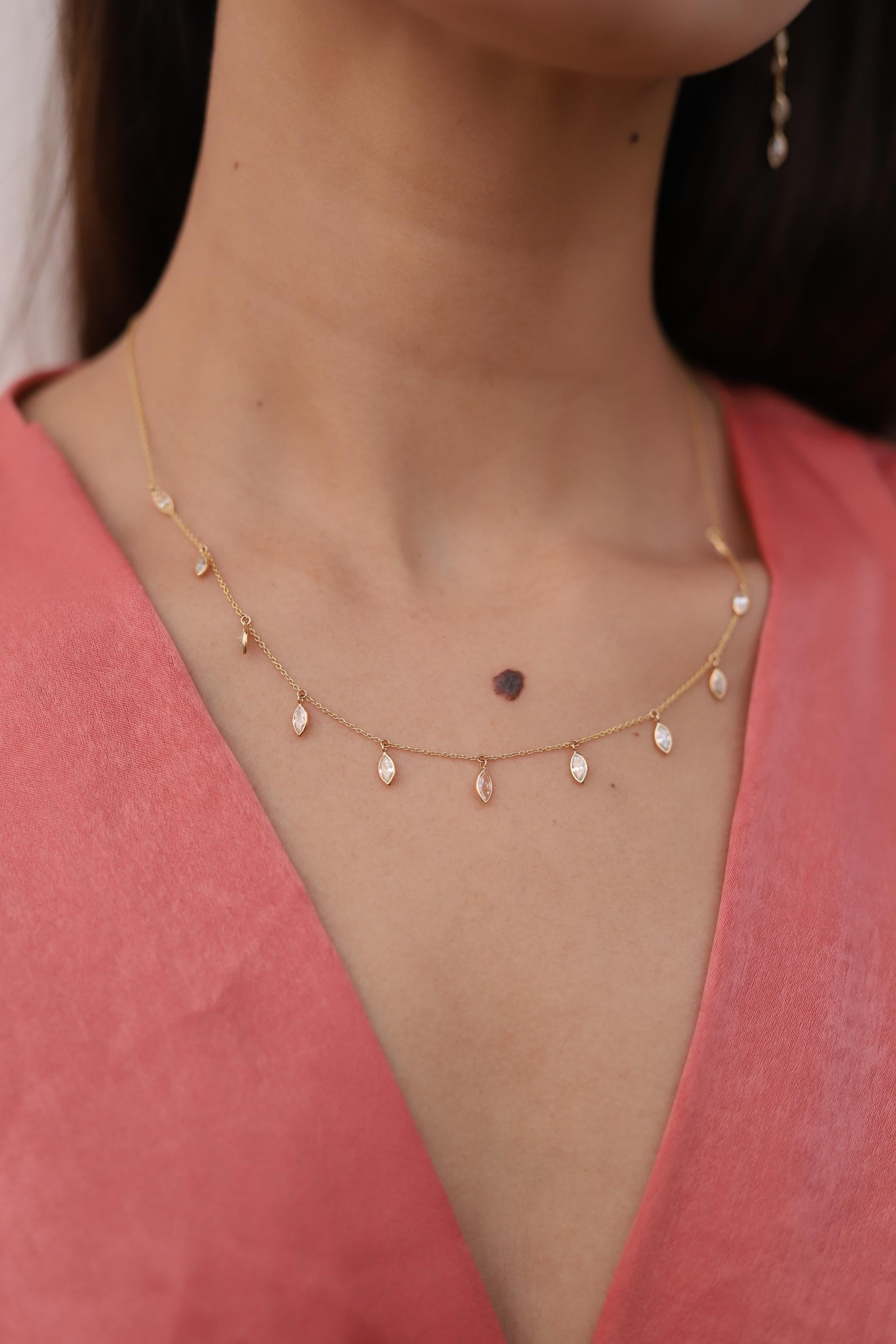 Diamond Necklace in 18K Gold studded with marquise cut diamonds.
Accessorize your look with this elegant diamond drop necklace. This stunning piece of jewelry instantly elevates a casual look or dressy outfit. Comfortable and easy to wear, it is