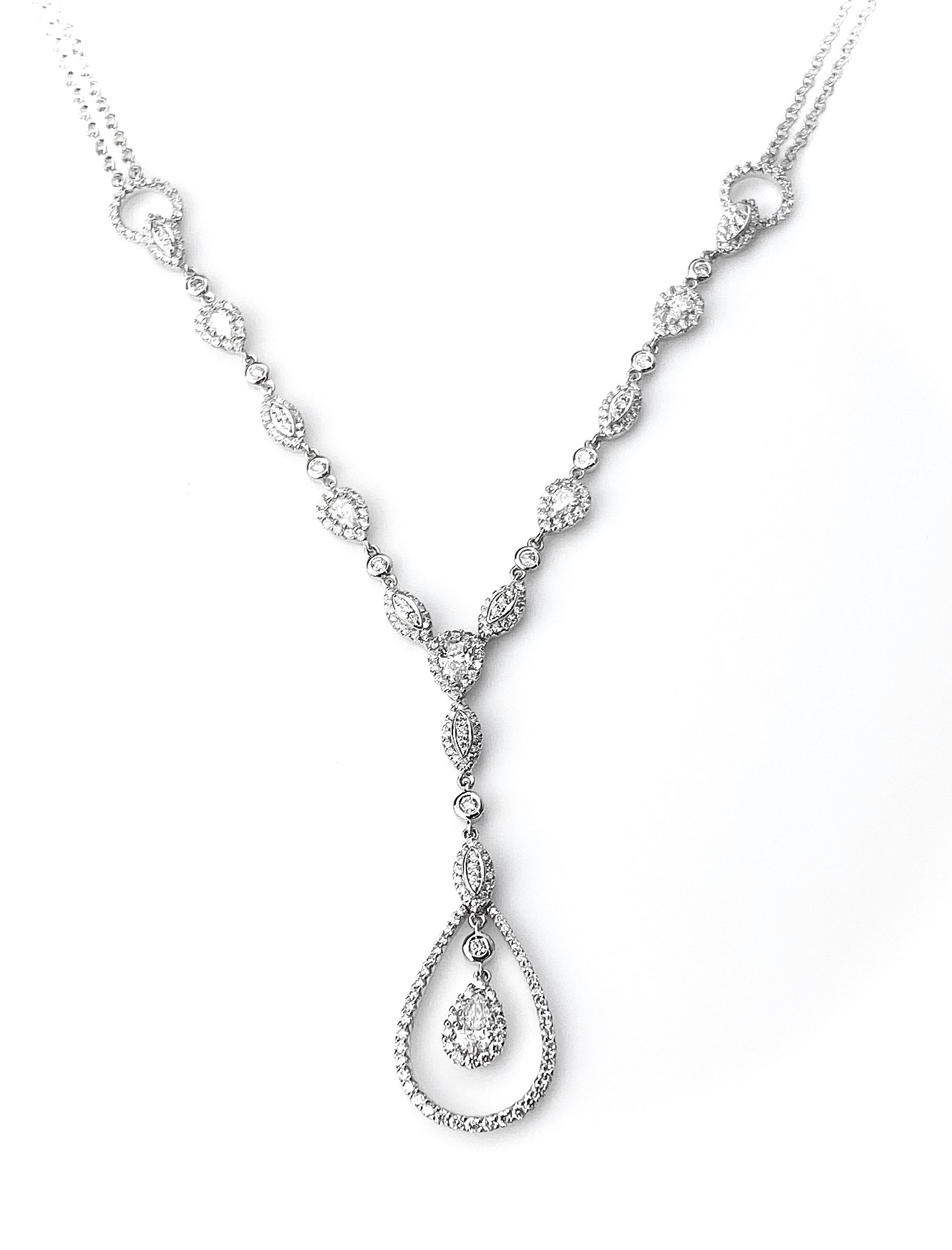 Elegant 18kt white gold diamond drop necklace with alternating pear cut diamonds surrounded by diamond halos, diamond cluster marquise shapes and bezel-set round brilliant diamonds. Set with a total of 301 diamonds equal to 1.94ct total. Presented