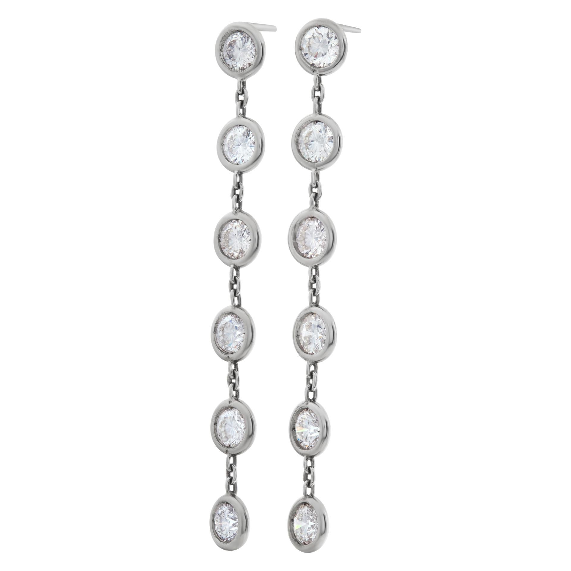 Bezel set diamond line drop earrings in platinum with approximately 5 carats total weight in round brilliant cut diamonds. Length 2.25 inches, width 6.5mm.