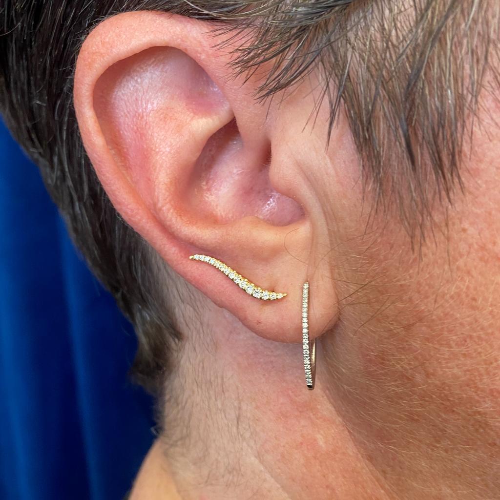 These fabulous Gabriel & Co. 14k gold ear climbers are accented with a gracefully graduated line dripping with diamonds provide a look that is both trendy and classic. These diamond earrings are a great staple to add to your collection, and can be