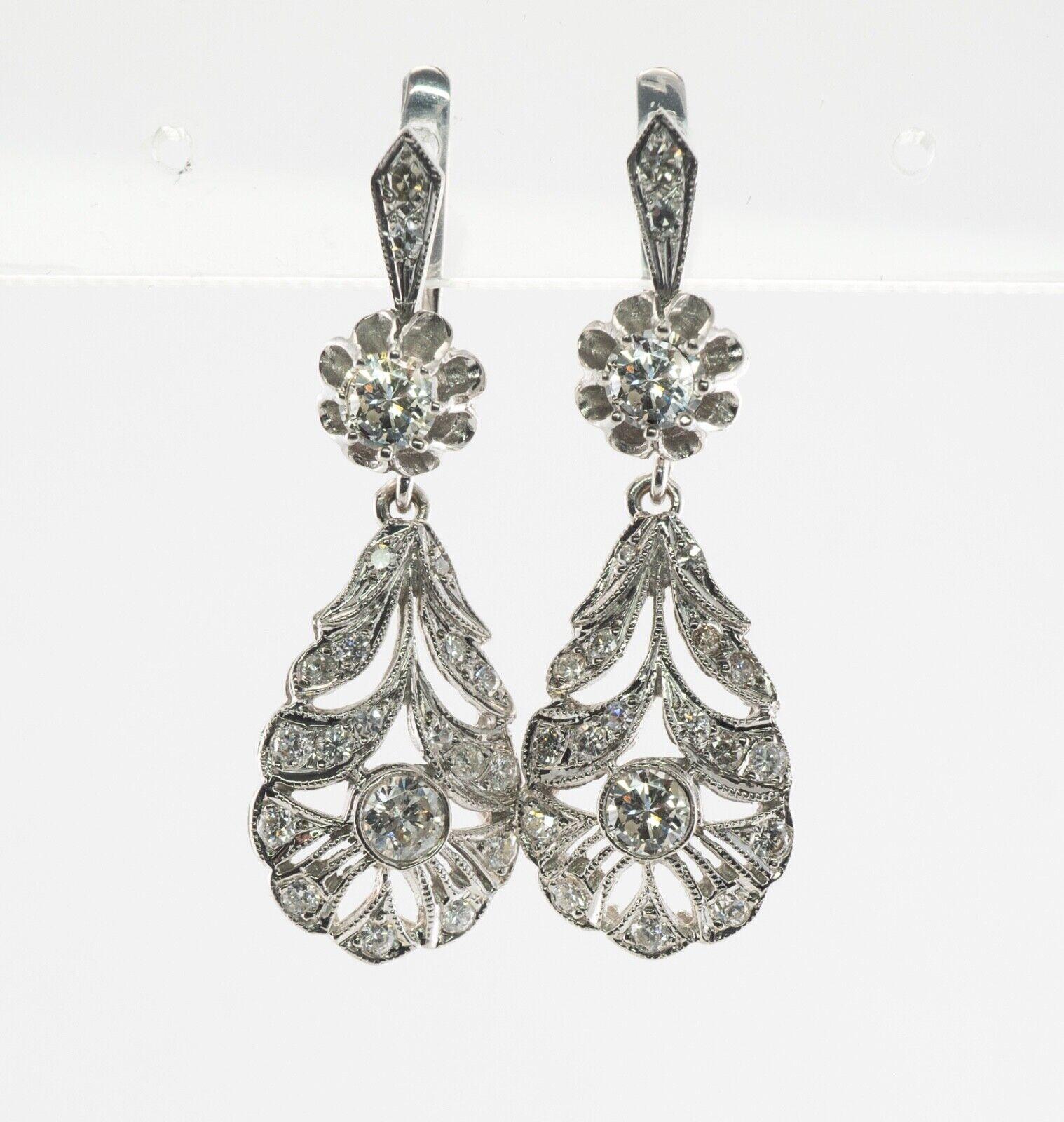 These gorgeous vintage earrings are crafted in solid 14K White Gold and set with natural diamonds. The buttercup setting on the top holds .25 carat diamond. The bezel-set diamond on the bottom is .30 carat. The fully millgrained top is encrusted