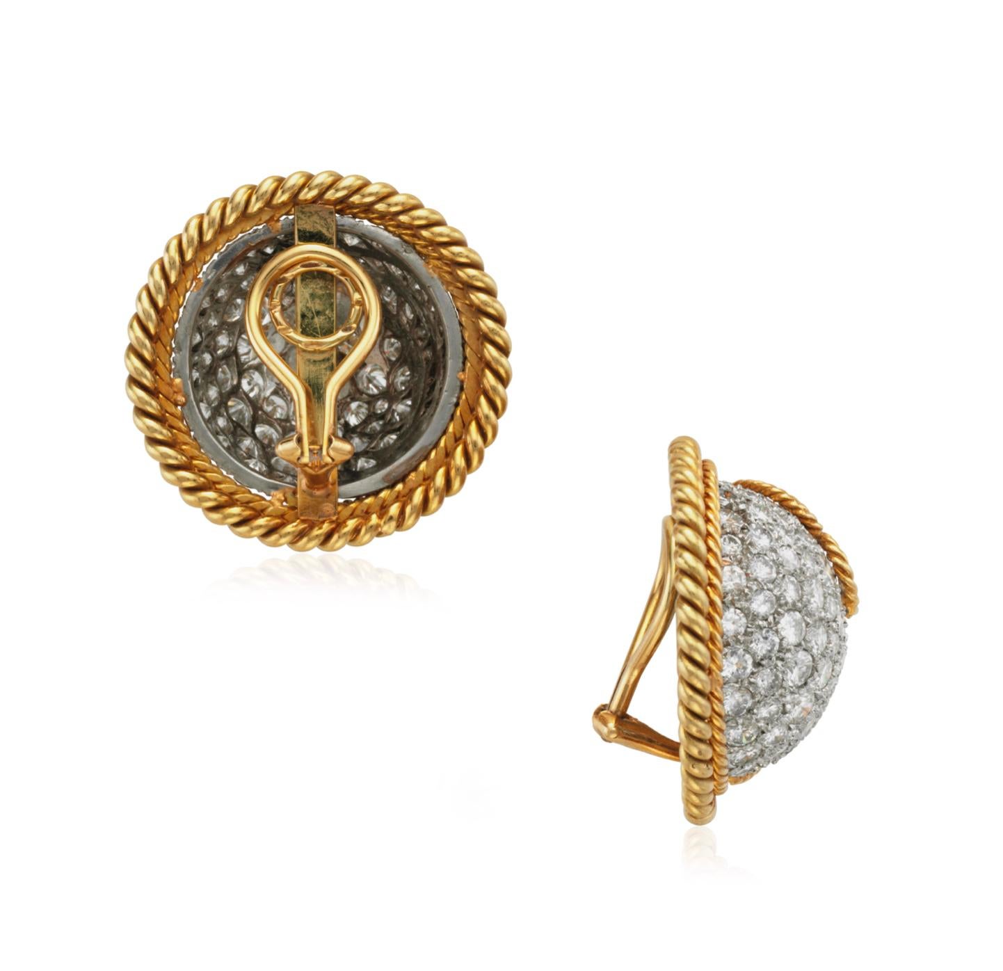 One pair of Platinum and 18 karat yellow gold earrings of bombe form, set with 166 round diamonds weighing approximately 5-6 carats. These earrings are roped with gold accents.