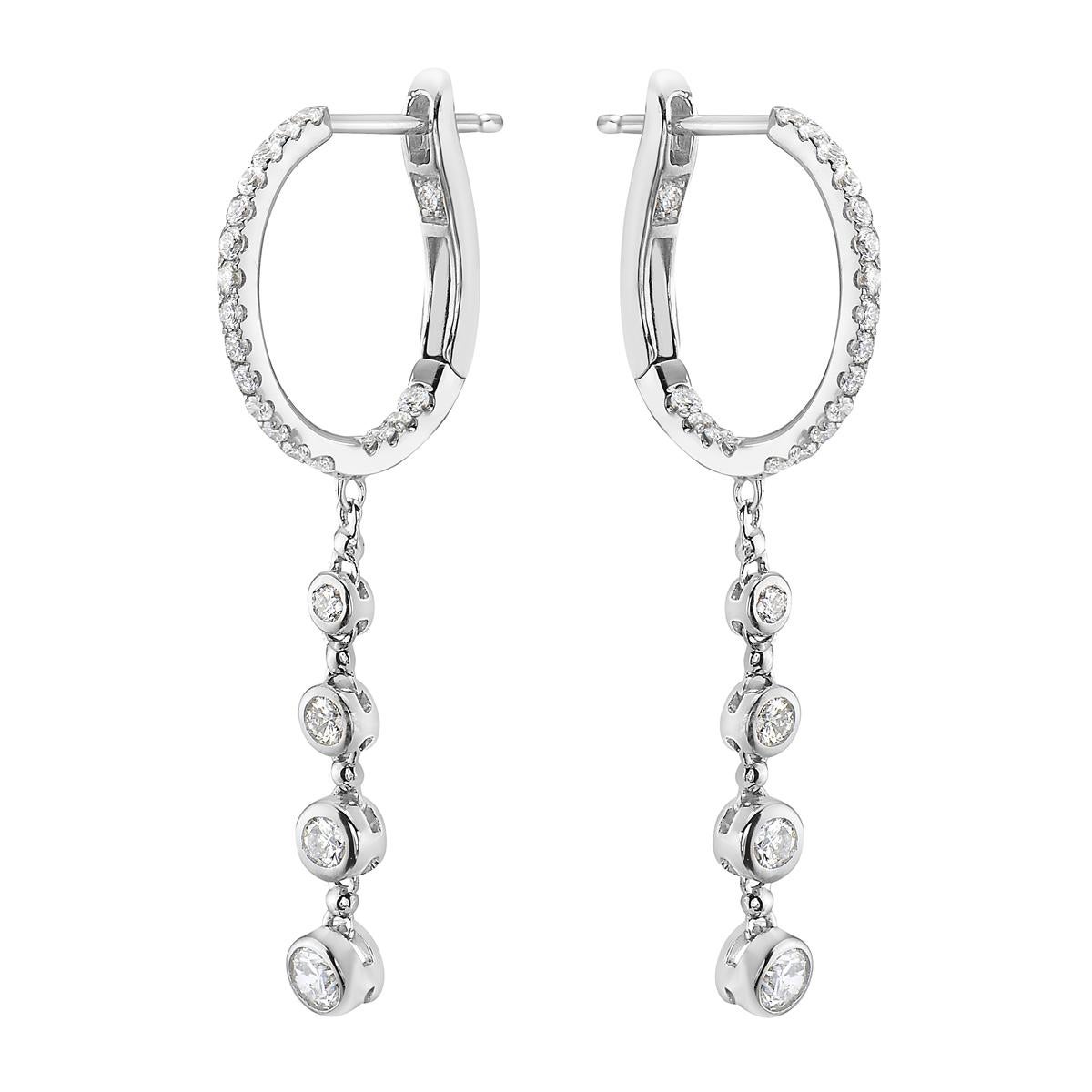 With these exquisite white-gold diamond earrings, style and glamour are in the spotlight. These earrings are set in 14-carat gold, made out of 3.1 grams of gold. The color of the diamonds is GH. The clarity is SI1-OSI2. These earrings are made out