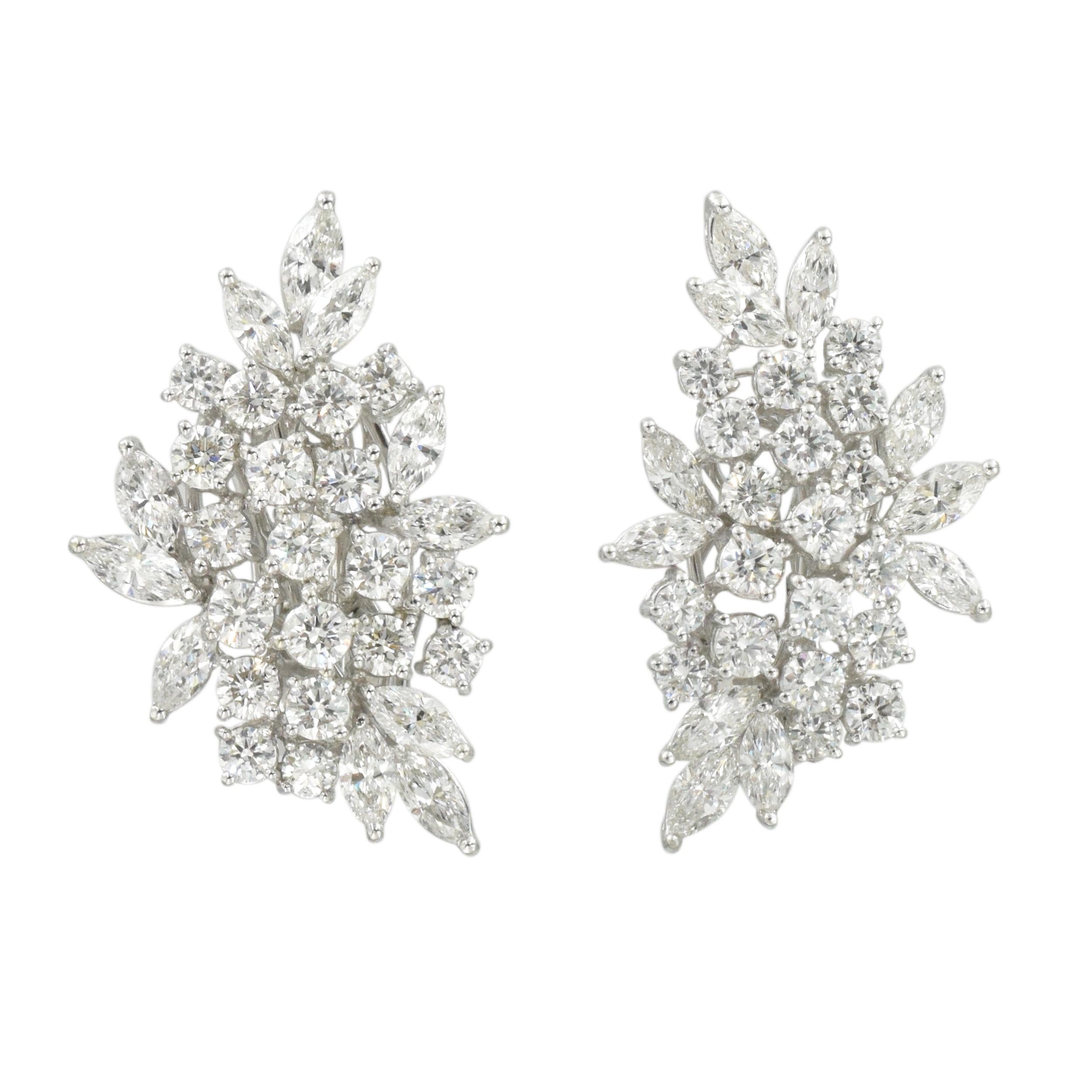 Diamond cluster ear-clips These earrings consist of 38 round brilliant cut and 22 marquise cut  with total weight of 7 carats of near colorless fine diamonds.
.The earrings are crafted in 18k white gold. 
Equipped with the hook for the drops and