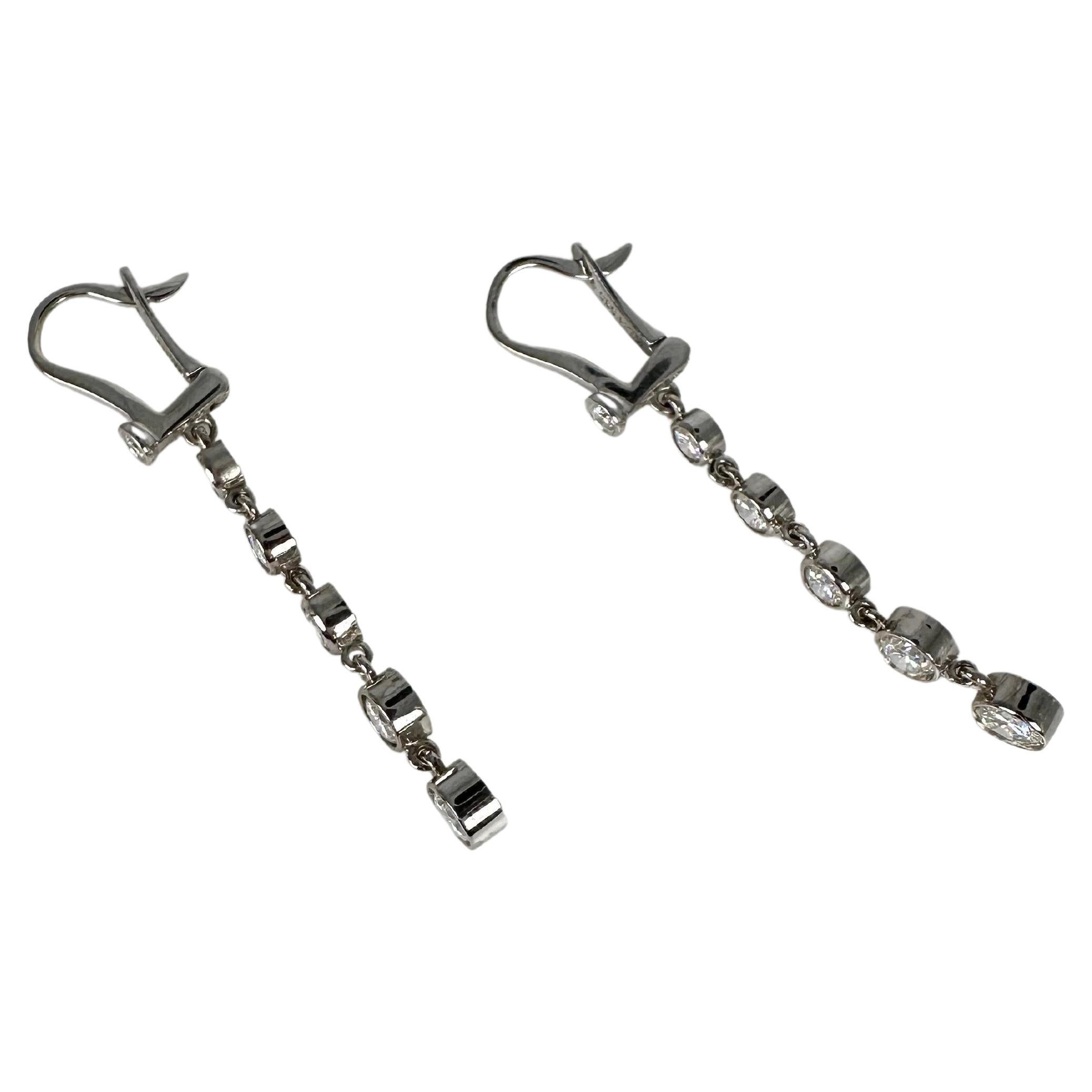Long dangling diamond earrings weighing 1.26 carats of sparkling diamonds in modern bezel setting. the lverback closure is so snug and comfortable for everyday wear! These earrings are absolutely lovely for those loving the long earrings!

GOLD: