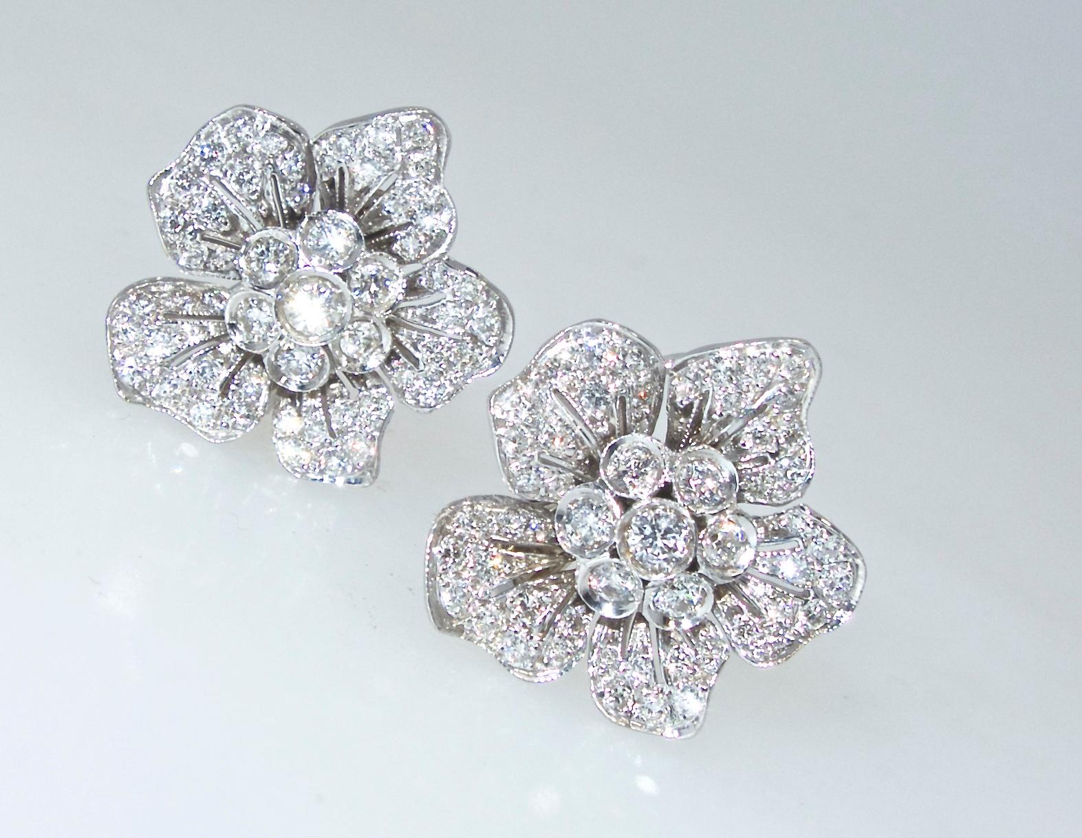 Diamonds weighing approximately 2.75 cts are finely arranged in a floral motif which sits on the ear.  These earrings can be for a pierced or non-pierced ear.  The diamonds are all near colorless (H), and very slightly included (VS).  These well