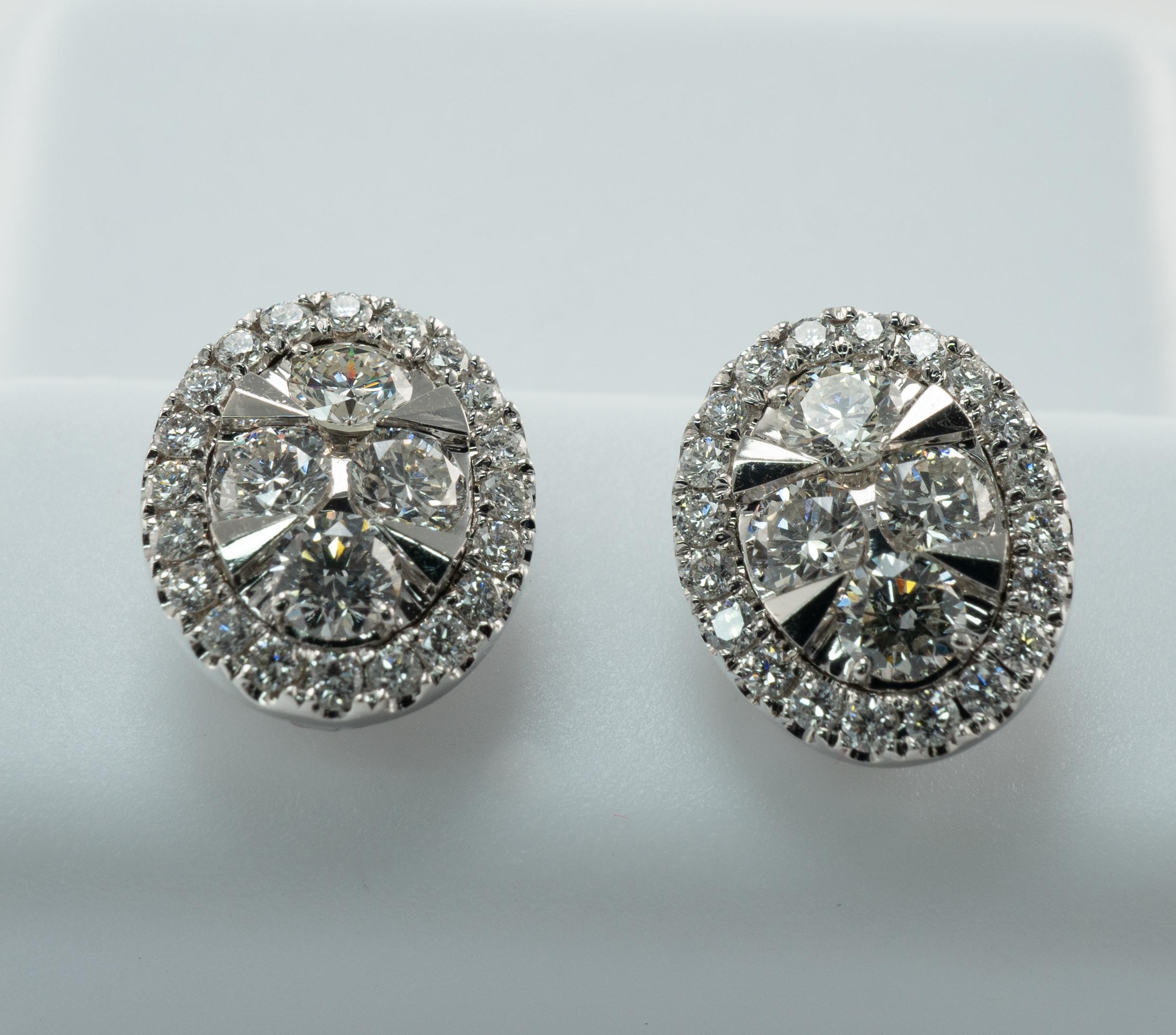 Diamond Earrings Round 14K White Gold Studs 1.04 ctw Oval shape

This pair of cluster stud diamond earrings is crafted in solid 14K White Gold. 
The center holds four round cut diamonds totaling .32 carat of VS1 clarity and H color.
The center is