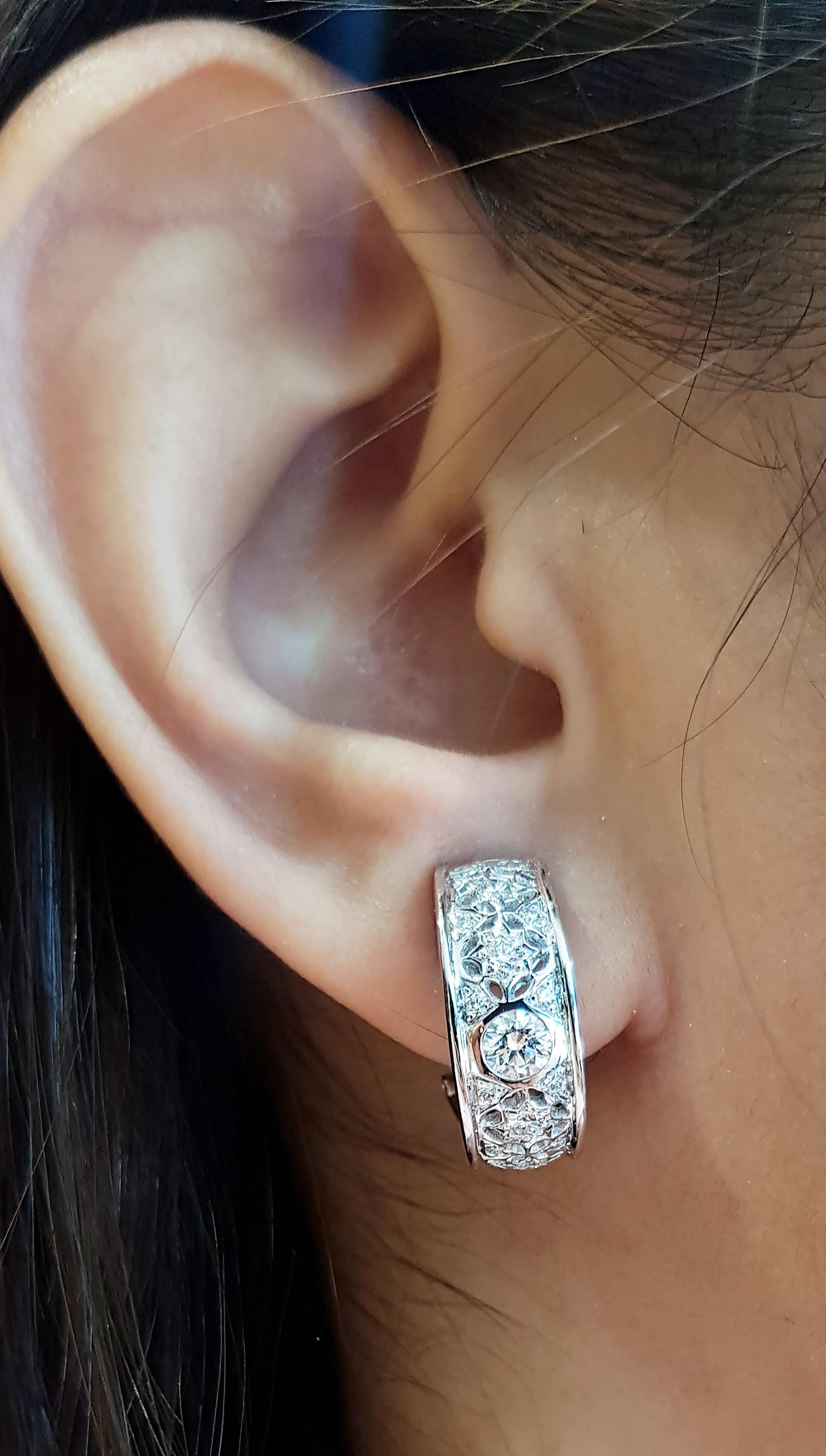 Diamond 0.88 carat Earrings set in 18 Karat White Gold Settings

Width:  0.7 cm 
Length: 1.7 cm
Total Weight: 8.75 grams

