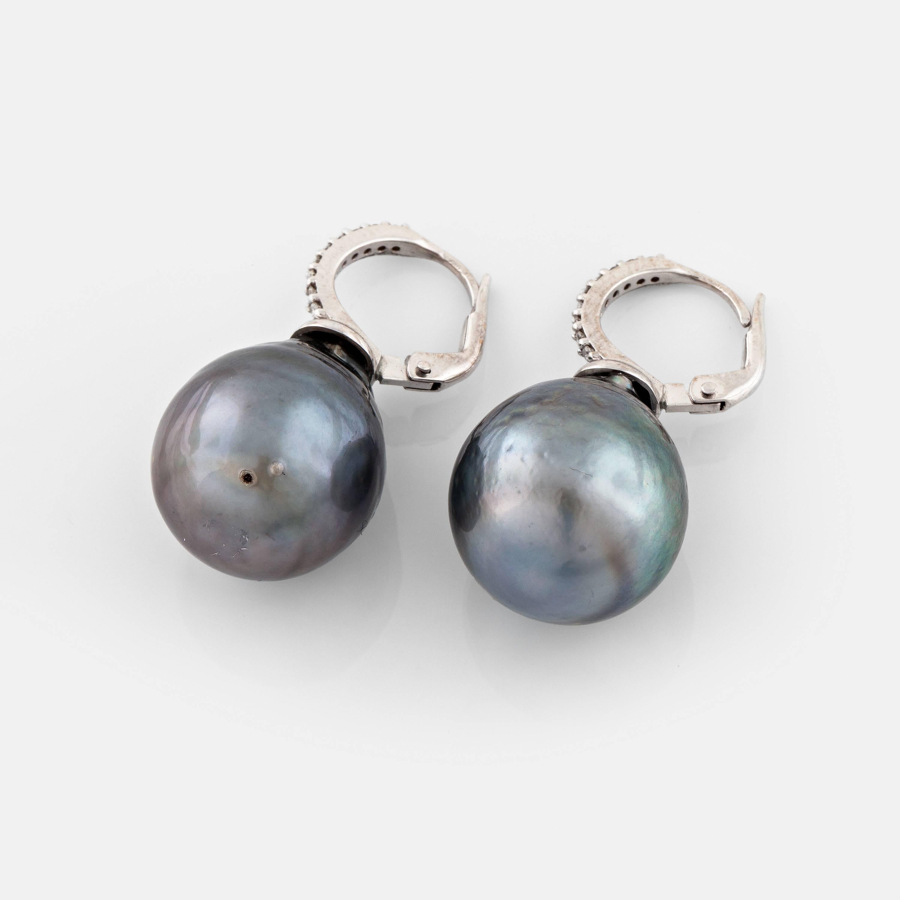 Wonderful and classic Tahitian pearl earrings with diamonds. The materials are 18 karat white gold and cultured pearls of about 16mm and total height of 3cm.