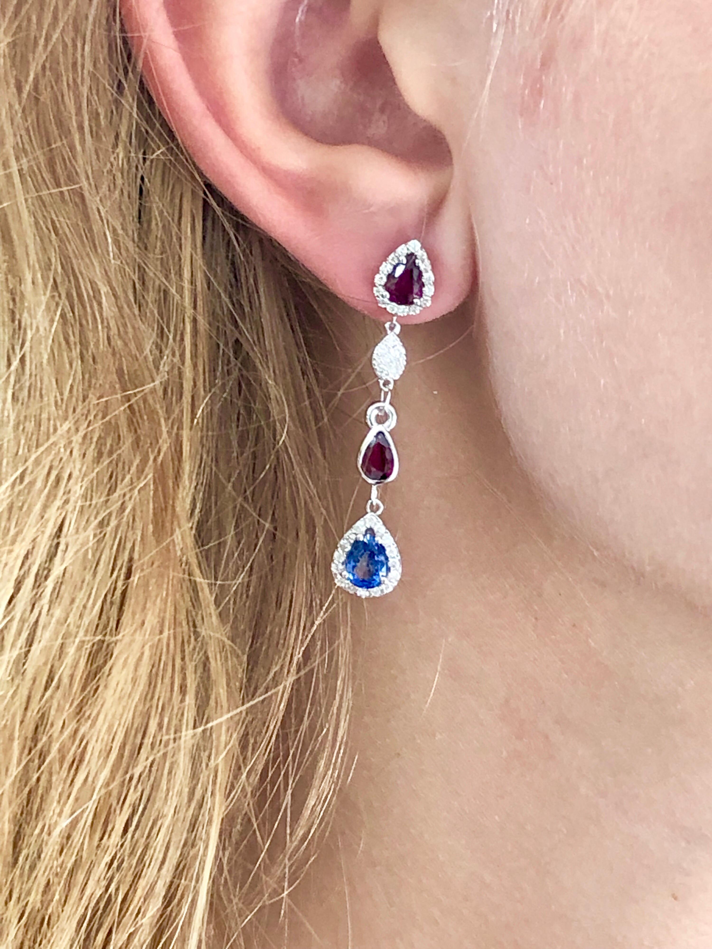 Fourteen karat white gold drop earrings two inch long
Diamonds weighing 1.25 carat 
Pear shape rubies weighing 2.01  carat
Pear shape sapphires weighing 1.70 carat
One of a kind earring
New Earrings
Handmade in the USA
Our team of graduate