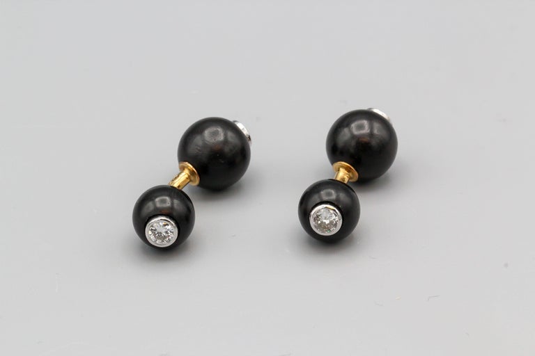 Fine pair of diamond and ebony wood on 18K gold dumbbell cufflinks. They feature 4 high grade round brilliant cut diamonds of approx. 1.50 carats total weight, bezel set on 18k white gold and expertly set of a polished ebony wood sphere.  Expertly