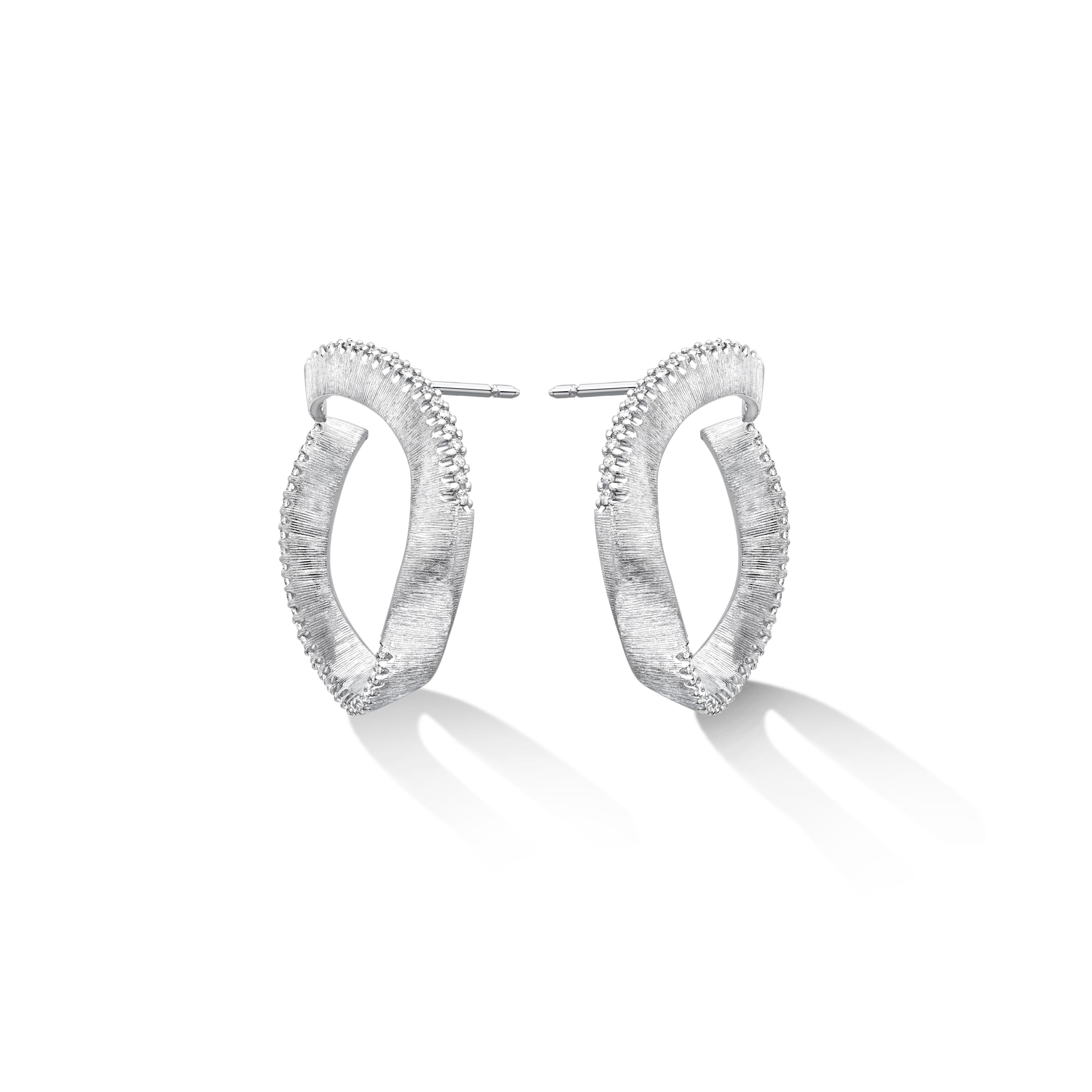 Liv Luttrell 
Diamond Edge Twist Hoop Earrings 2020

Details
18-karat white gold 
Natural white diamonds, Colour F+, Clarity VS+
Silk engraving
Made in London 


Customisation 

As this design is handmade to your order, Liv is able to customise the