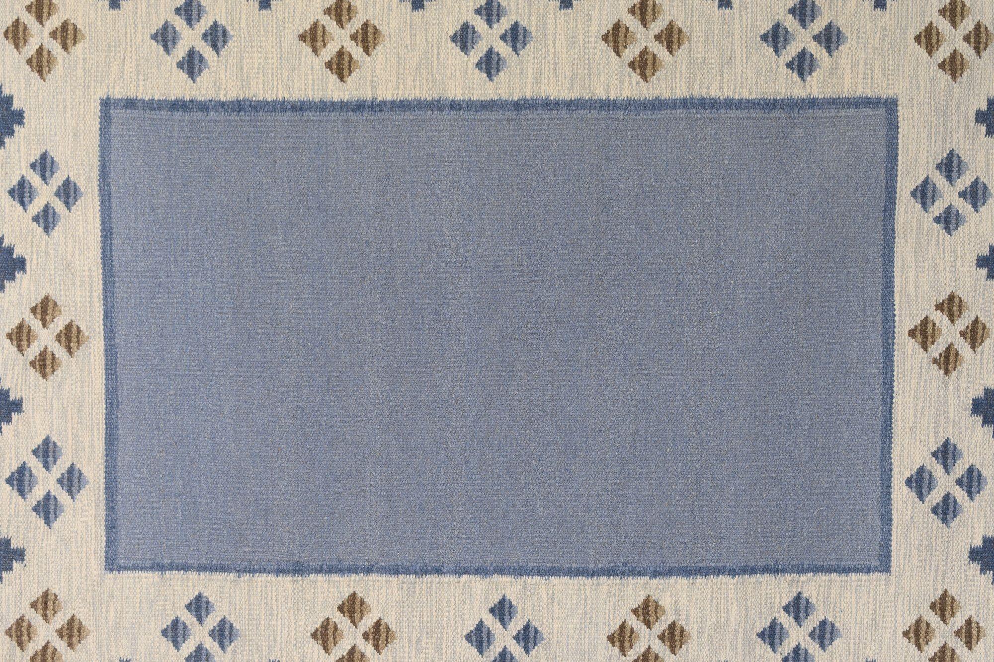 Diamond edge pattern Swedish mid-century rug in tones of blues and cream. Sweden circa 1960. All our carpets undergo a professional cleaning process. However, due to their age and previous life, some may exhibit minor signs of wear consistent with