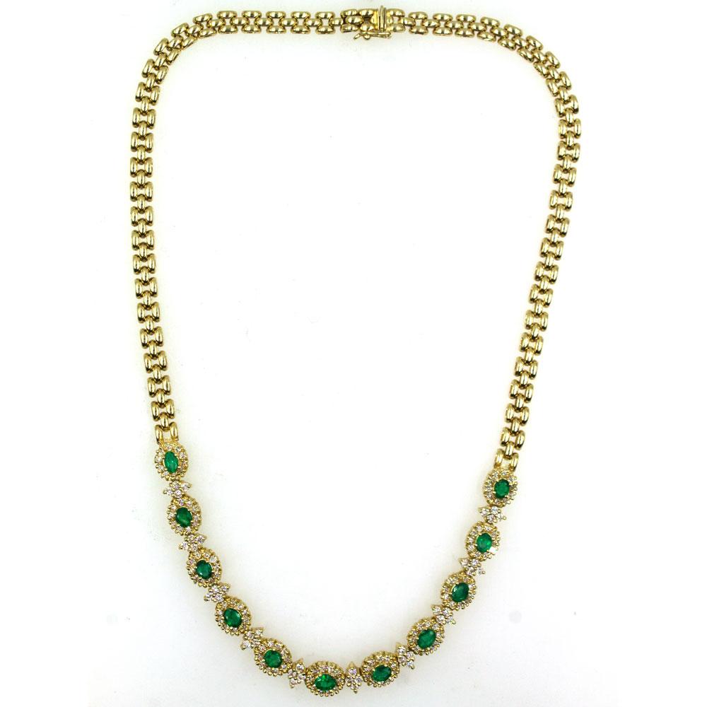 An array of emeralds and diamonds are set in this yellow gold link necklace. The necklace features 11 oval cut emeralds (3.80 carat total weight) surrounded by 182 round brilliant cut diamonds (3.50 carat total weight). The necklace measures 17