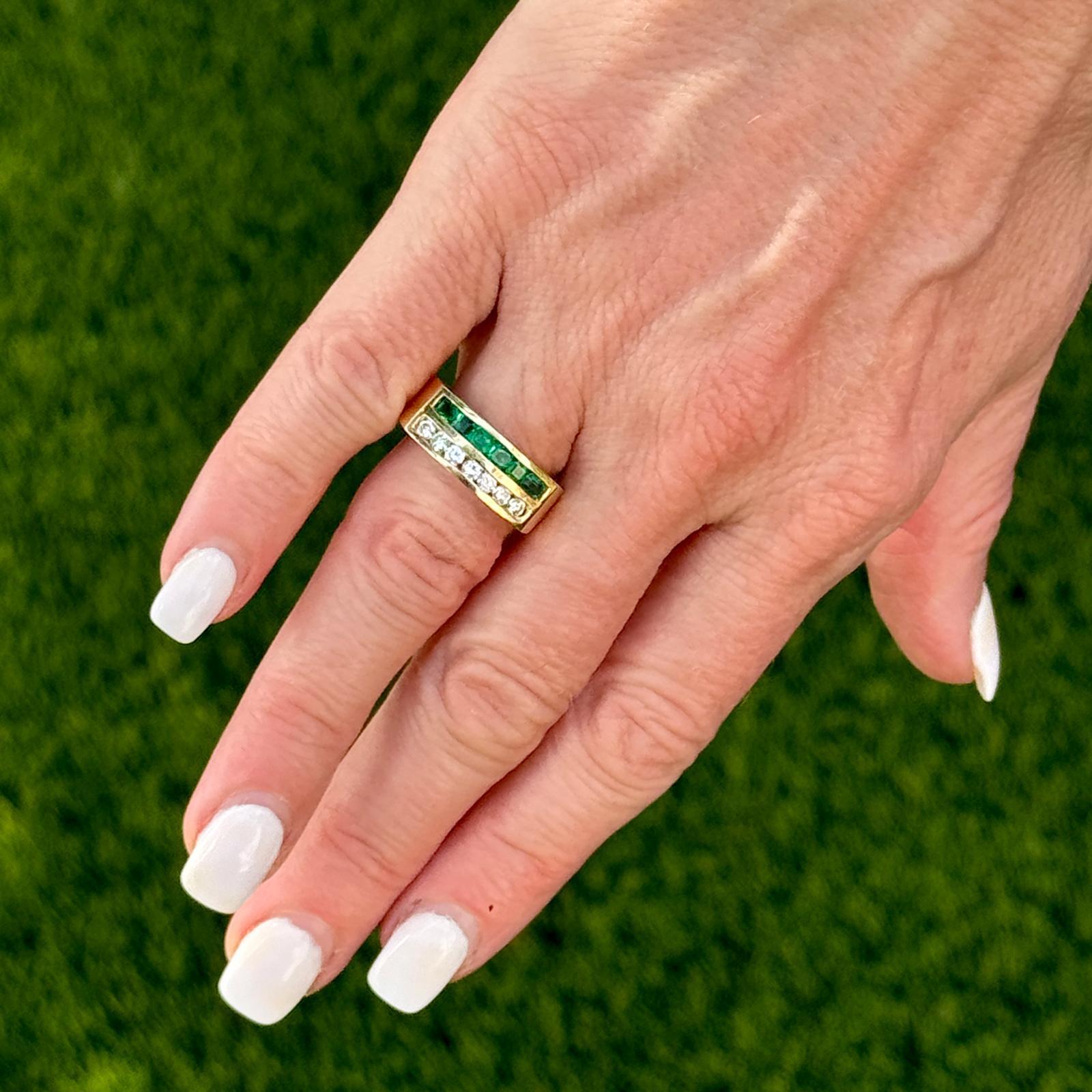 This diamond and emerald band ring is crafted in 18 karat yellow gold. The combination of yellow gold with the brilliance of diamonds and the vibrant green of emeralds creates a rich and luxurious aesthetic. The 7 round briliant cut diamonds weigh