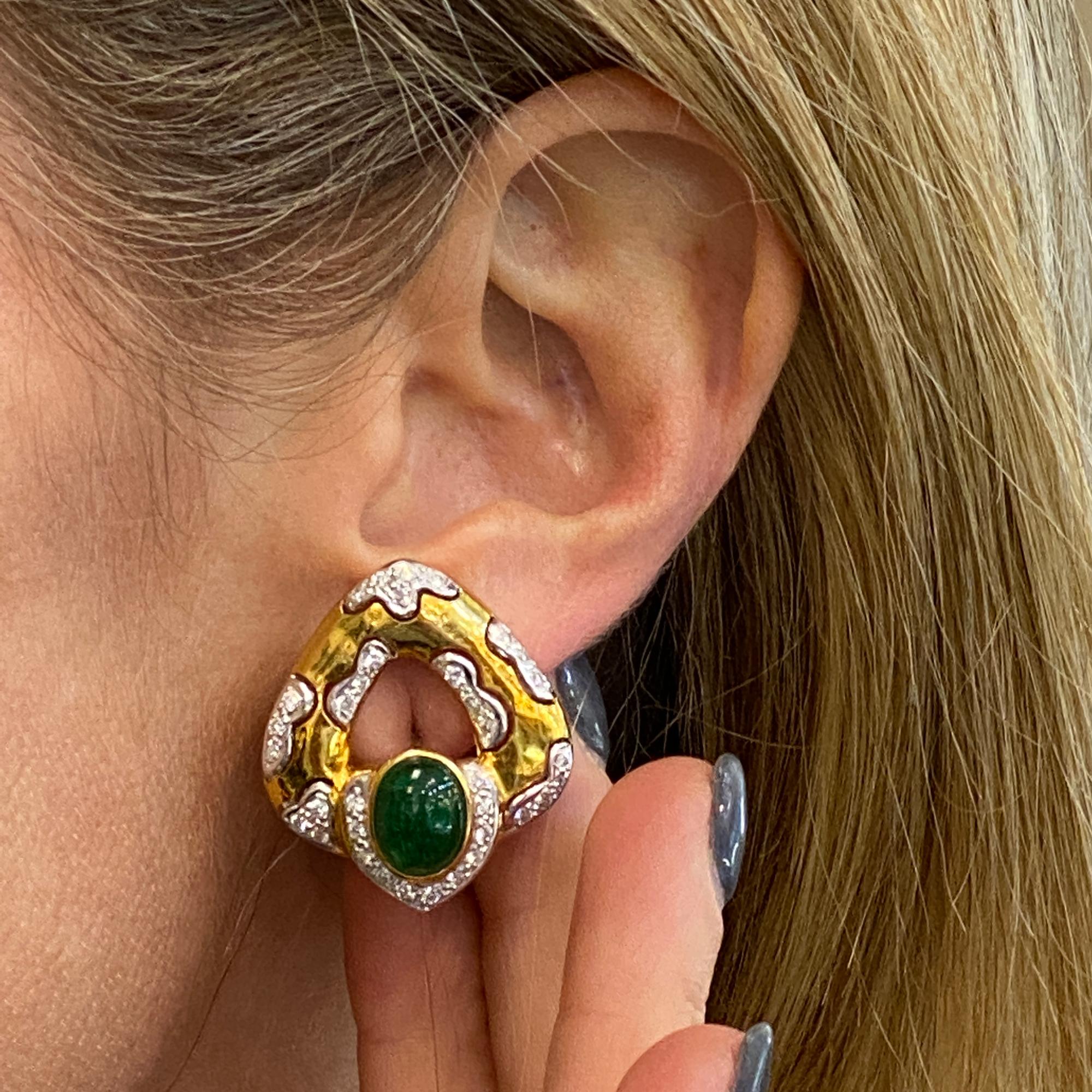 Diamond and emerald triangular shaped earrings are circa 1980's. The earrings are fashioned in 18 karat yellow gold and feature 2 cabochon emeralds weighing approximately 4.00 carat total weight, and high quality round brilliant cut diamonds
