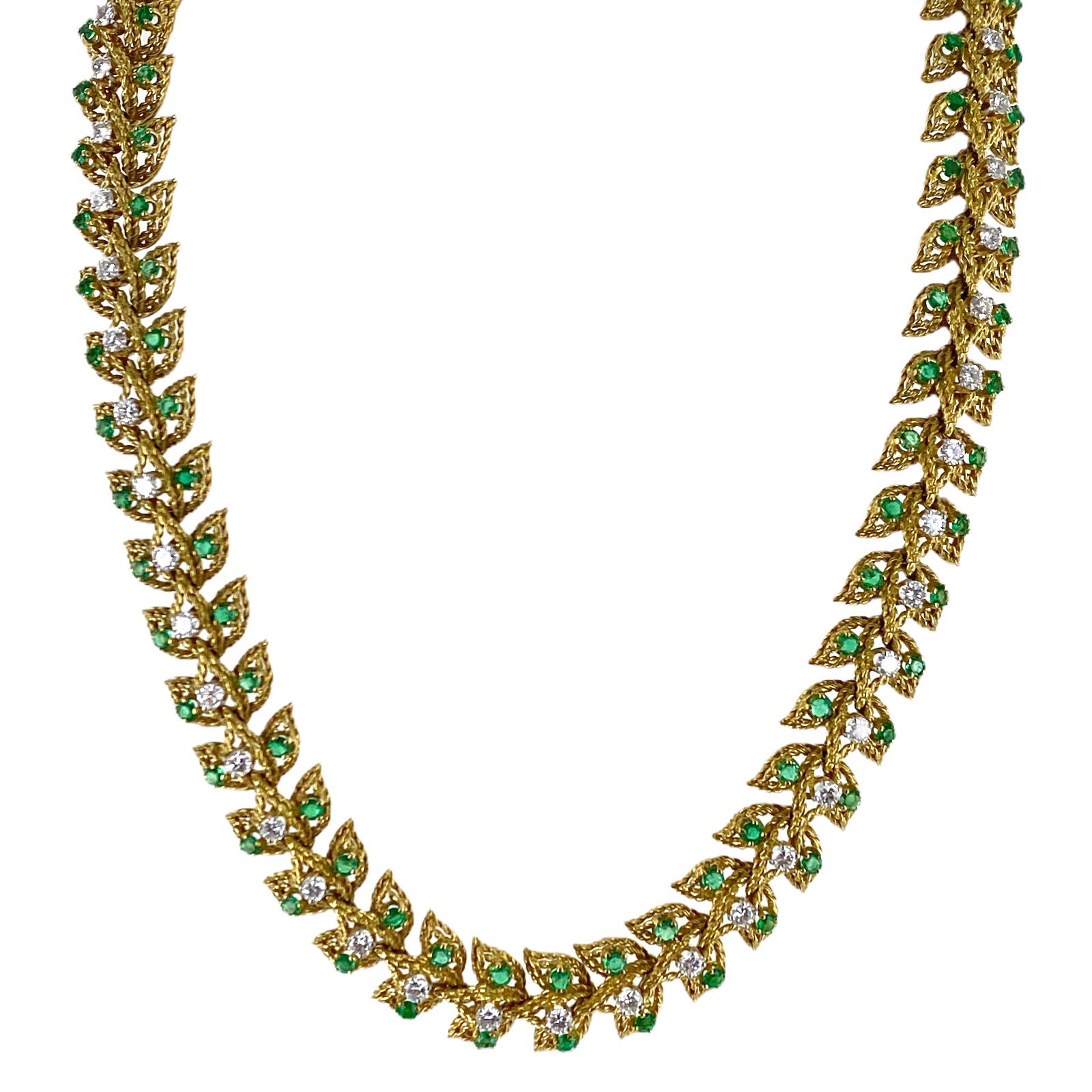 Stunning diamond emerald leaf motif necklace crafted in 18 karat yellow gold. The necklace features 47 round brilliant cut diamonds weighing approximately 4.00 carat total weight and graded F-H color and VS clarity. The necklace also is set with 94