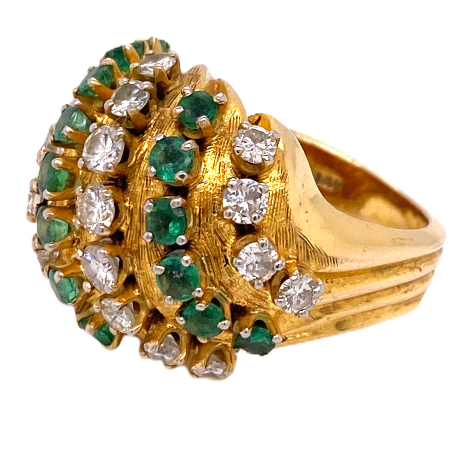 Beautiful diamond emerald dome ring fashioned in 18 karat yellow gold. The ring features 18 round brilliant cut diamonds weighing approximately 1.80 carat total weight and graded G-I color and VS clarity. The rows of diamonds alternate with 18 round