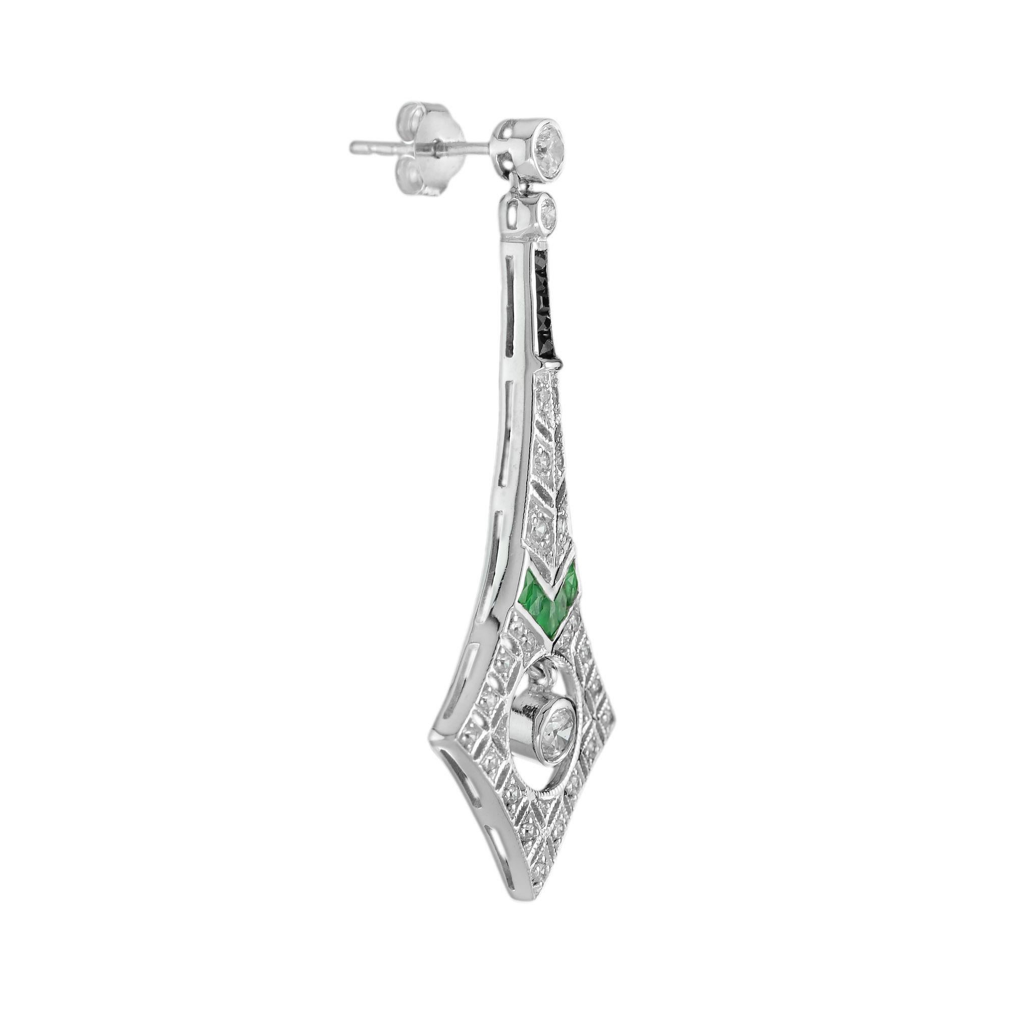 These Art Deco inspired diamond emerald and onyx drop earrings in white gold/platinum are a luxurious decadence to be enjoyed for years to come. Each earrings is adorned with a total of four-teen French cut emeralds, five onyxes and sparkling