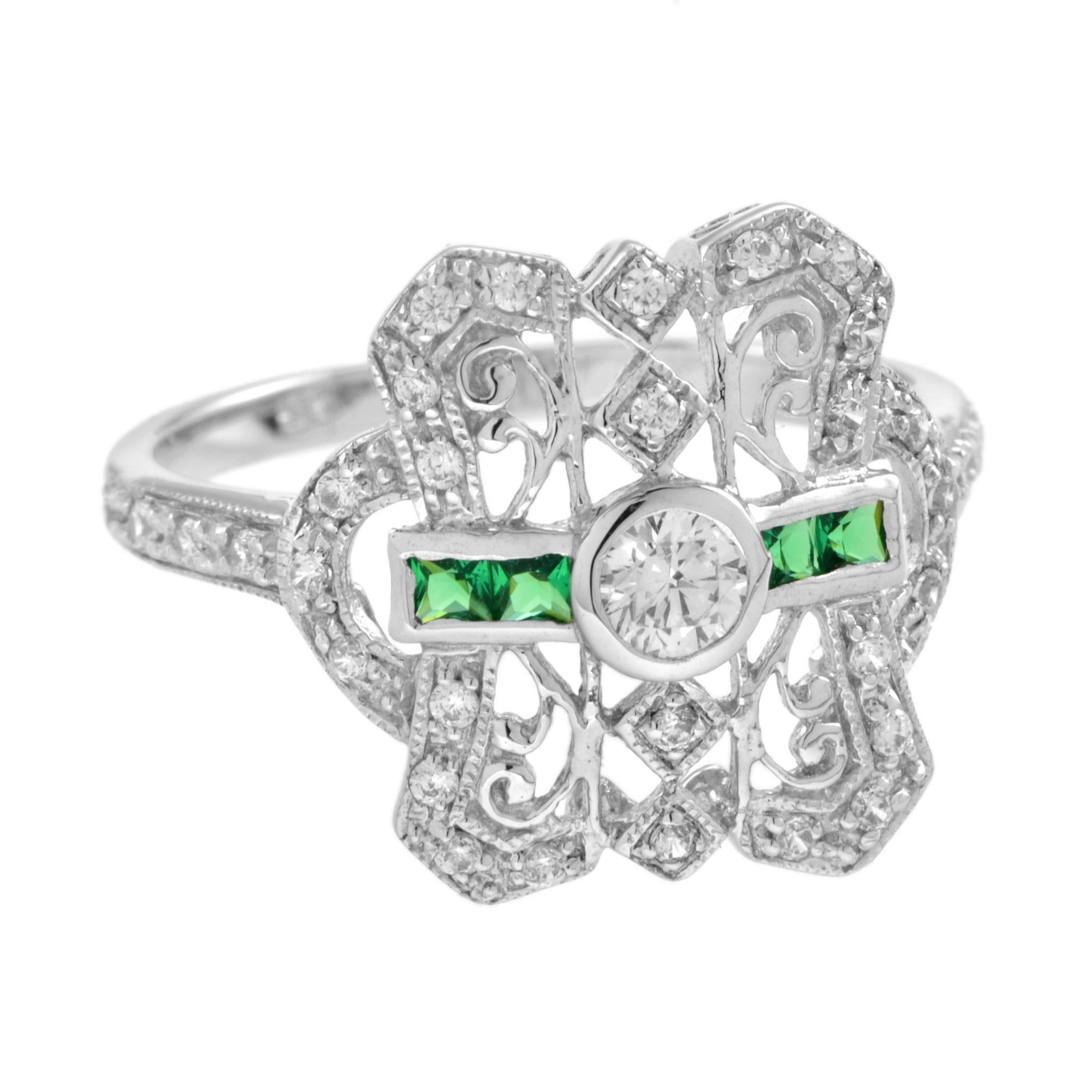 An Art Deco inspired diamond and emerald white gold filigree ring. Featuring one round brilliant cut diamond of approximately 0.17 carat, graded H color, SI clarity. Accented by 4 French cut emerald and 34 round cut diamonds. Wear this ring daily to