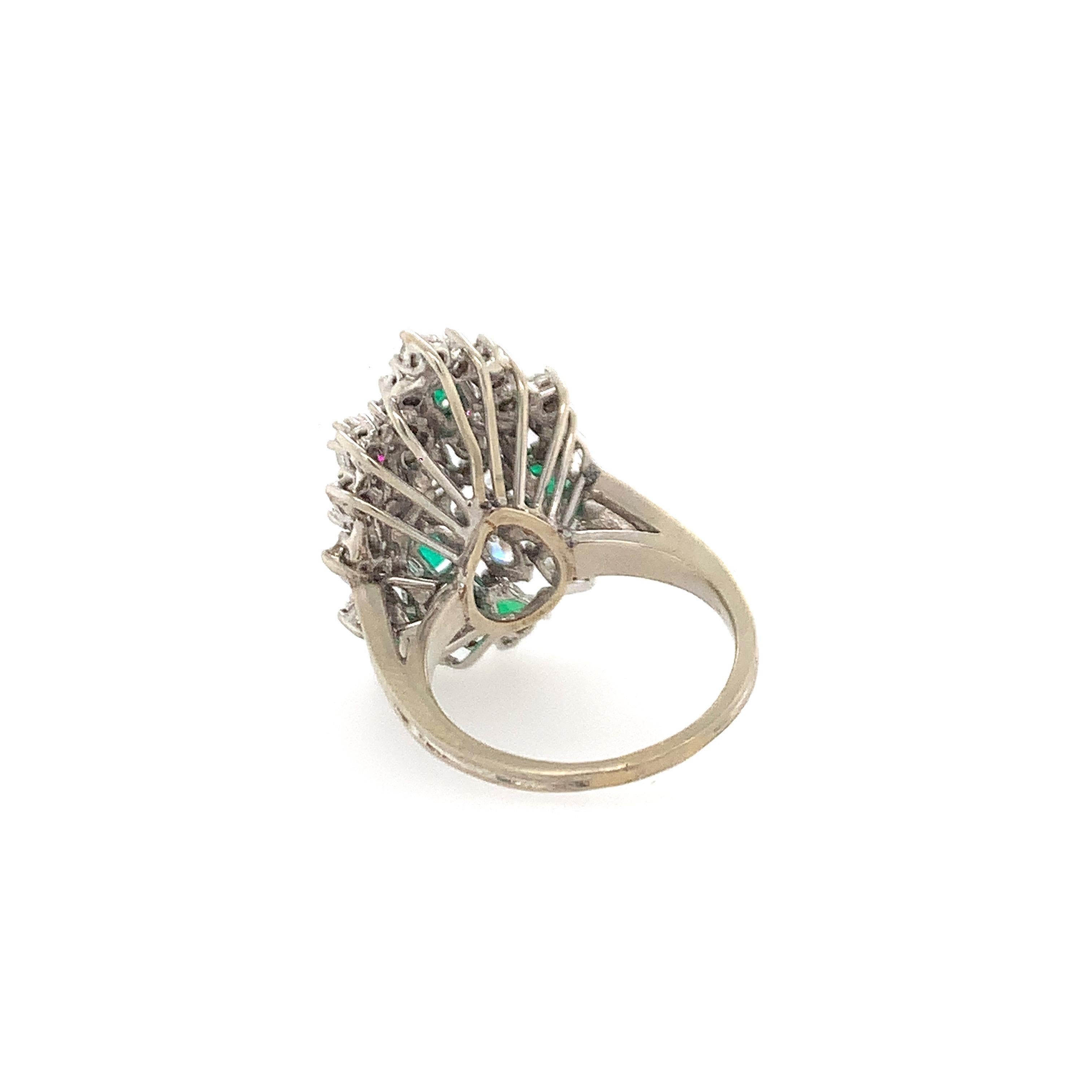 14K W/gold multi-shaped diamonds and emeralds.  Diamonds weighing approx. 3.00 cts, JK VS-SI emerald weighing approx. 1 ct, to of ring meausres 1 1/2 inches, weight 6.4 dwt