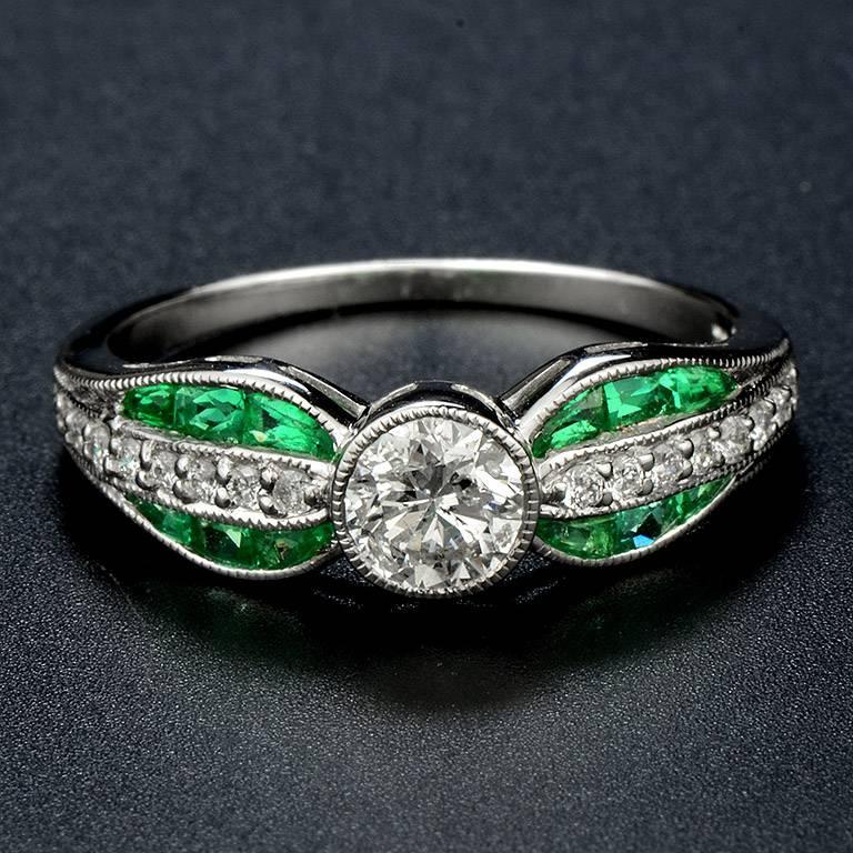 Brilliant Cut Diamond 0.50 Carat Set in the center and another 16 pieces 0.13 Carat on the shoulders. High-lighted by French Cut Zambian Emerald with 12 pieces 0.98 Carat.

The Ring was made in 18k White Gold Size US#7